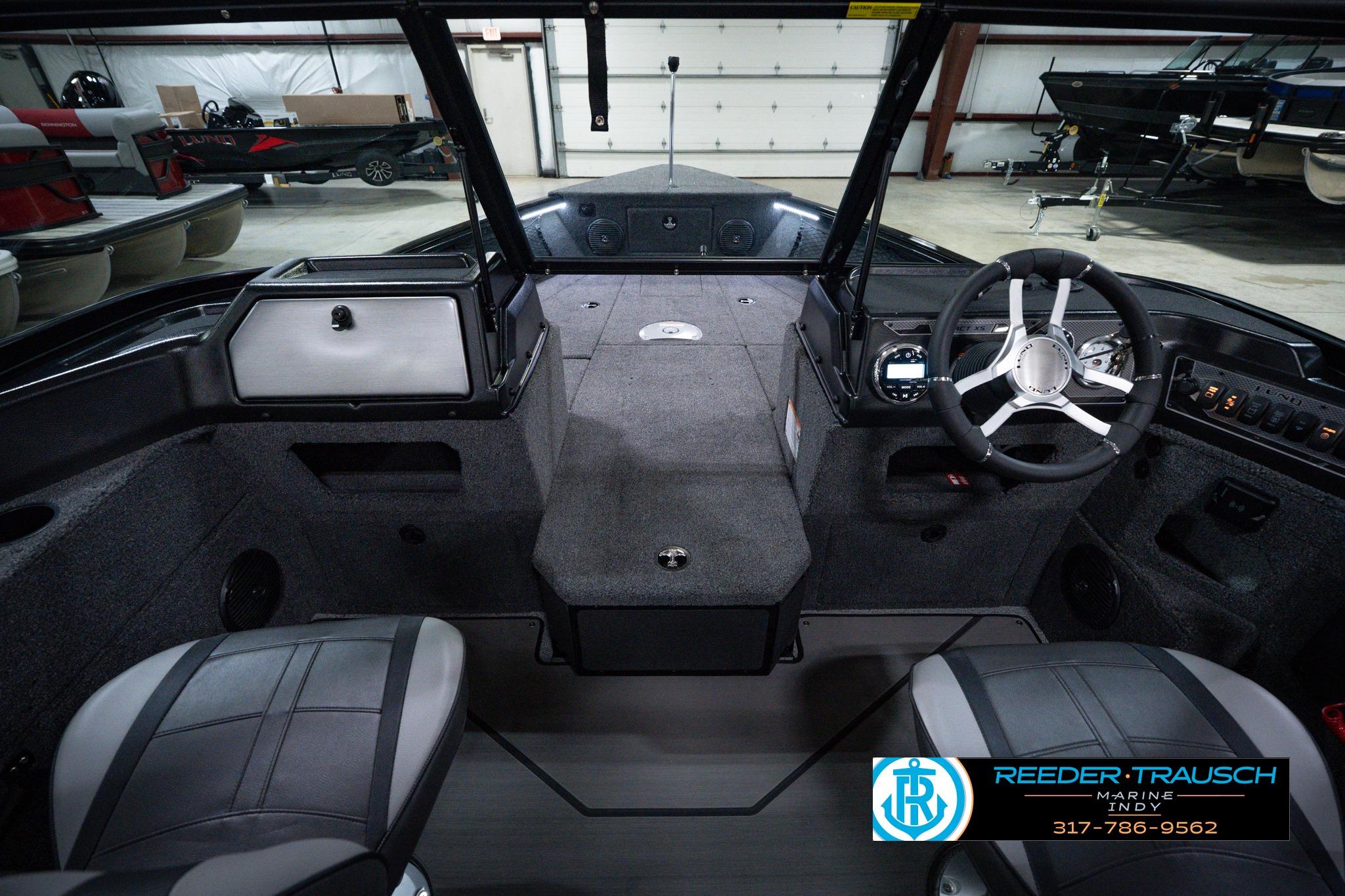 Interior view of 2026 Lund 1875 Impact XS SS boat, featuring steering wheel and seating.
