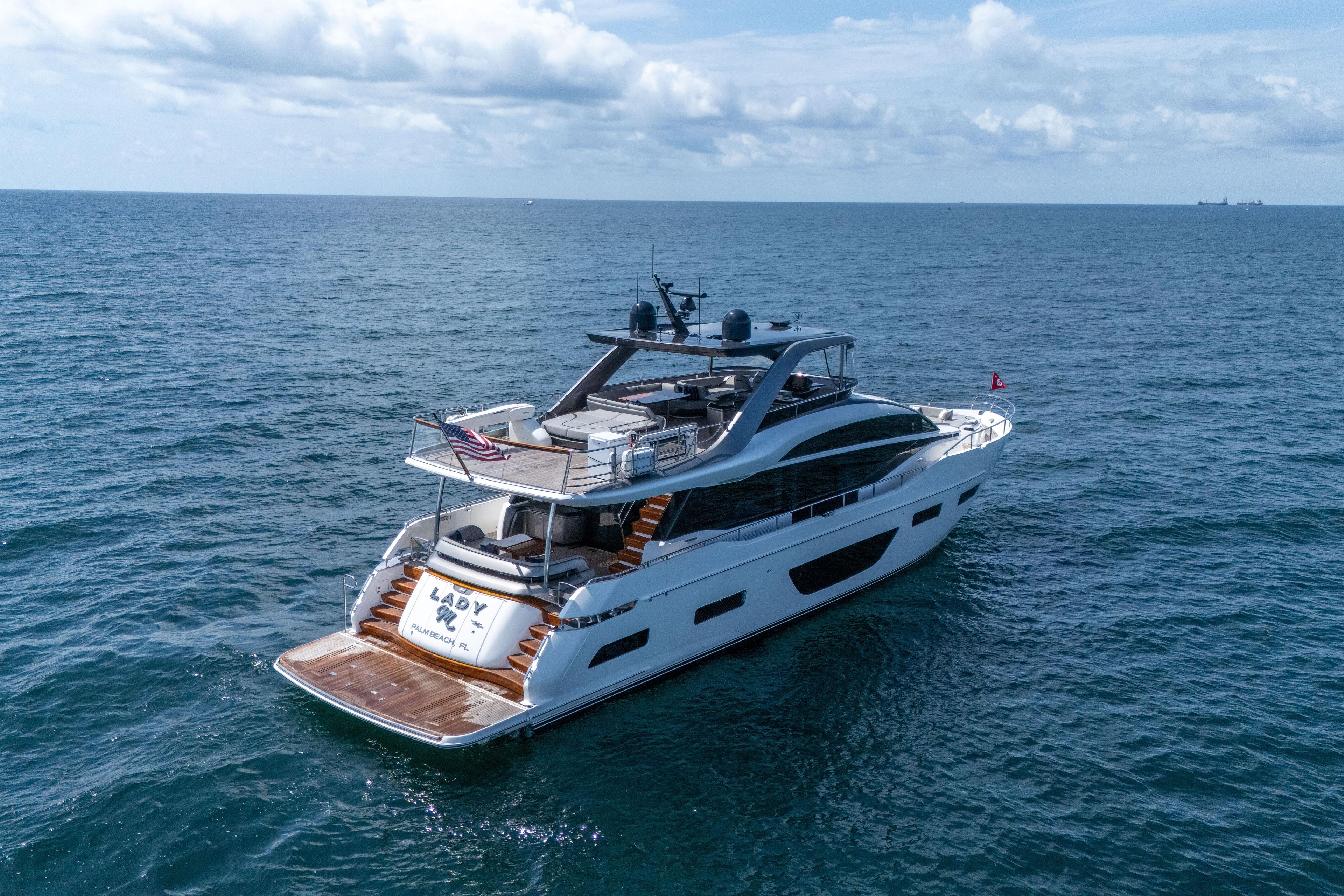 Luxurious 2020 Princess Y85 yacht cruising on open sea under a cloudy sky.