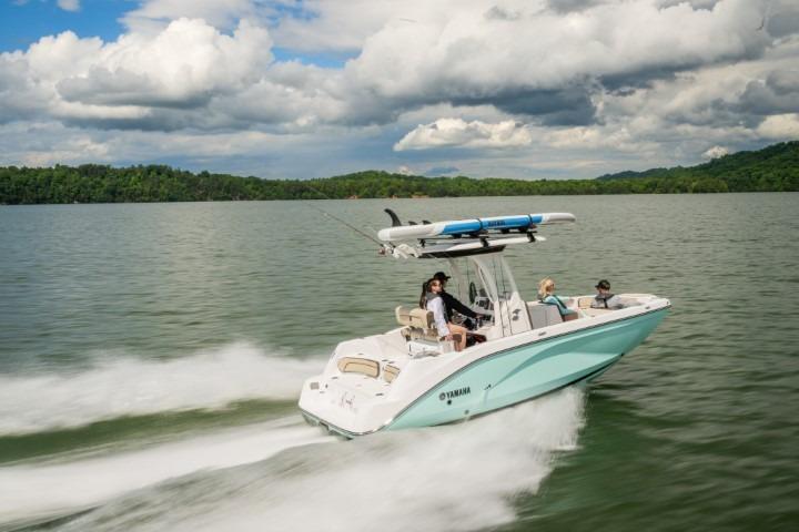 2026 Yamaha Boats 222 FSH Sport E cruising on a lake under cloudy skies.