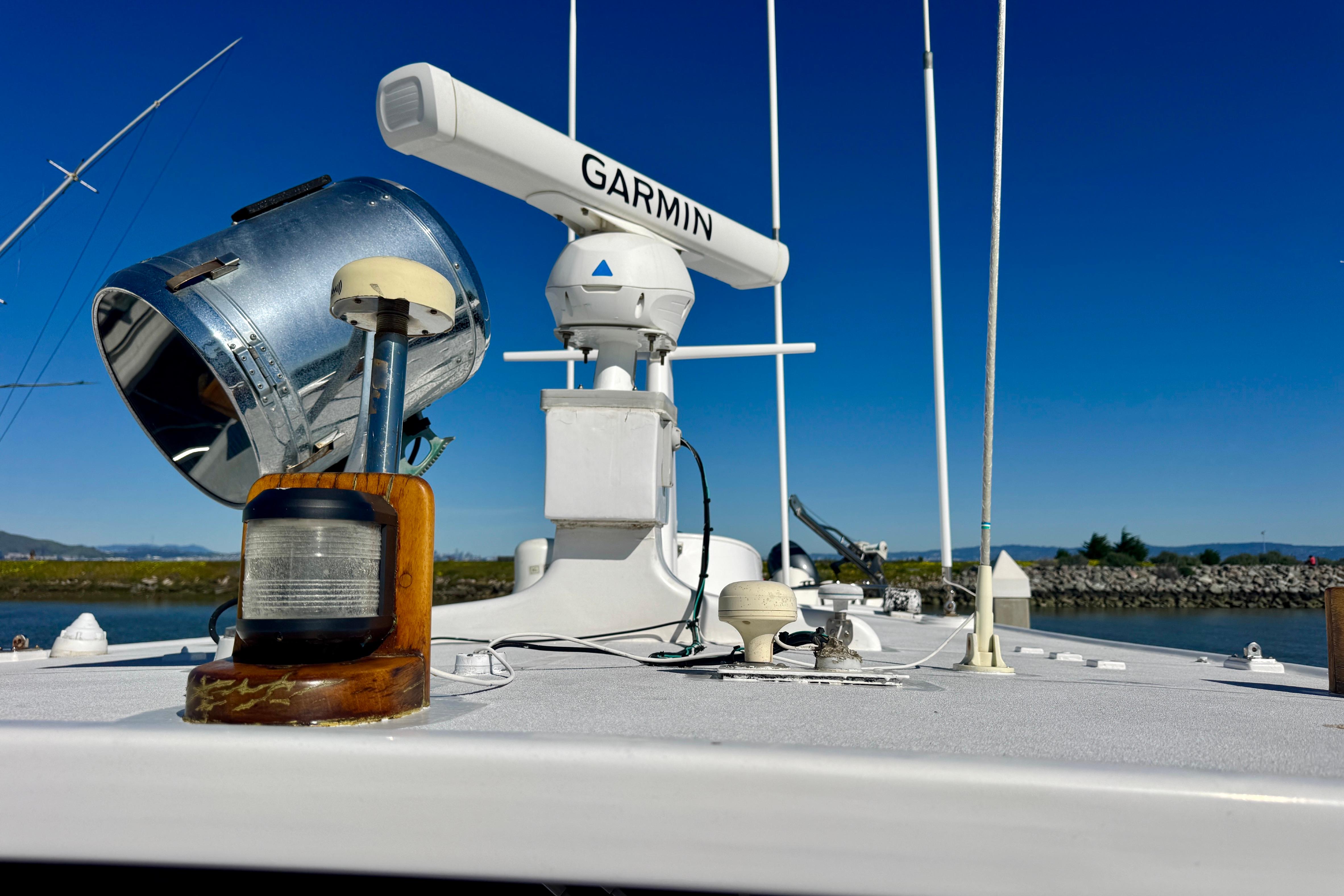 1958 Blanchard Pilothouse boat deck with Garmin radar and vintage spotlight.