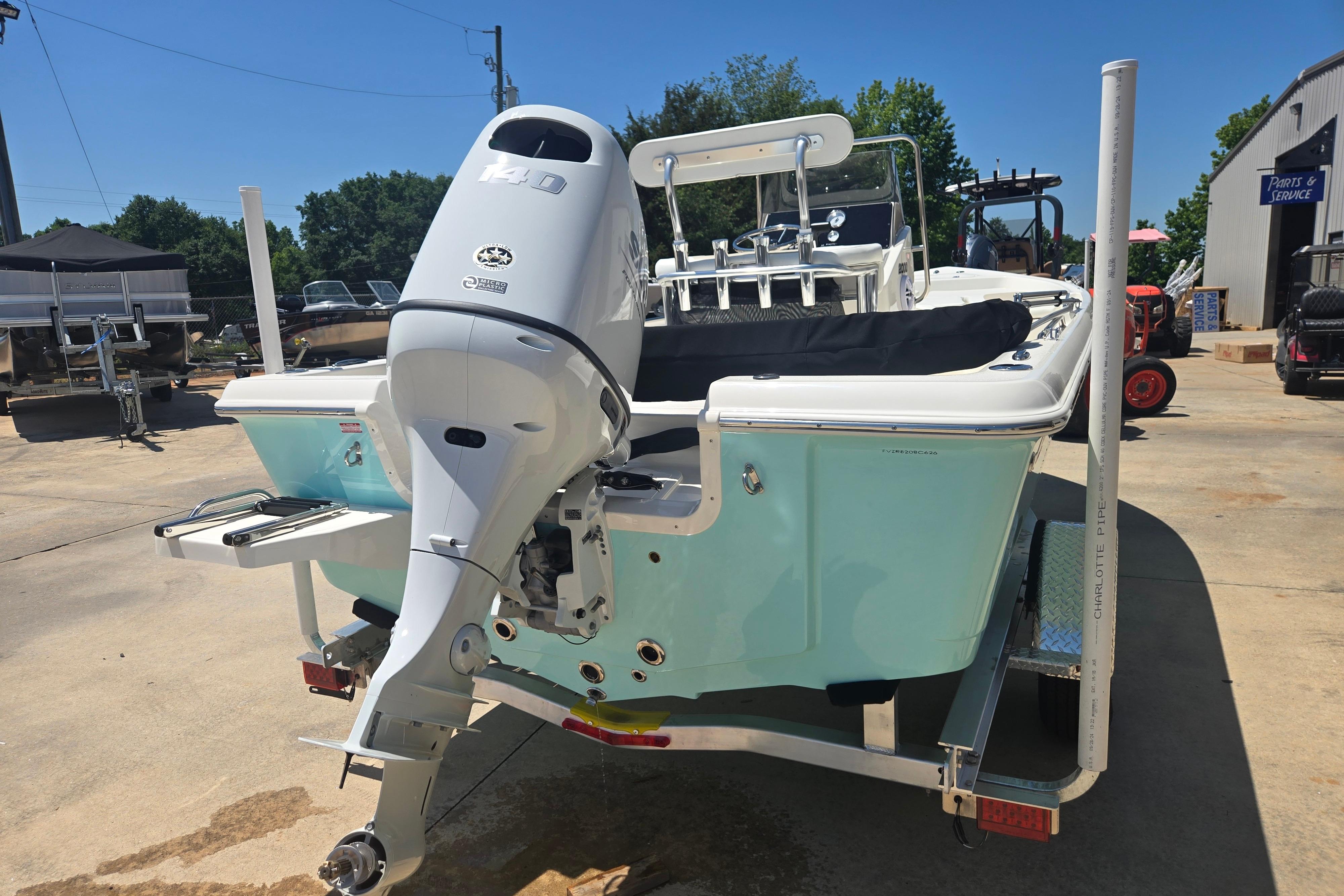 2026 Bulls Bay 2000 boat with outboard motor on trailer, parked outdoors.