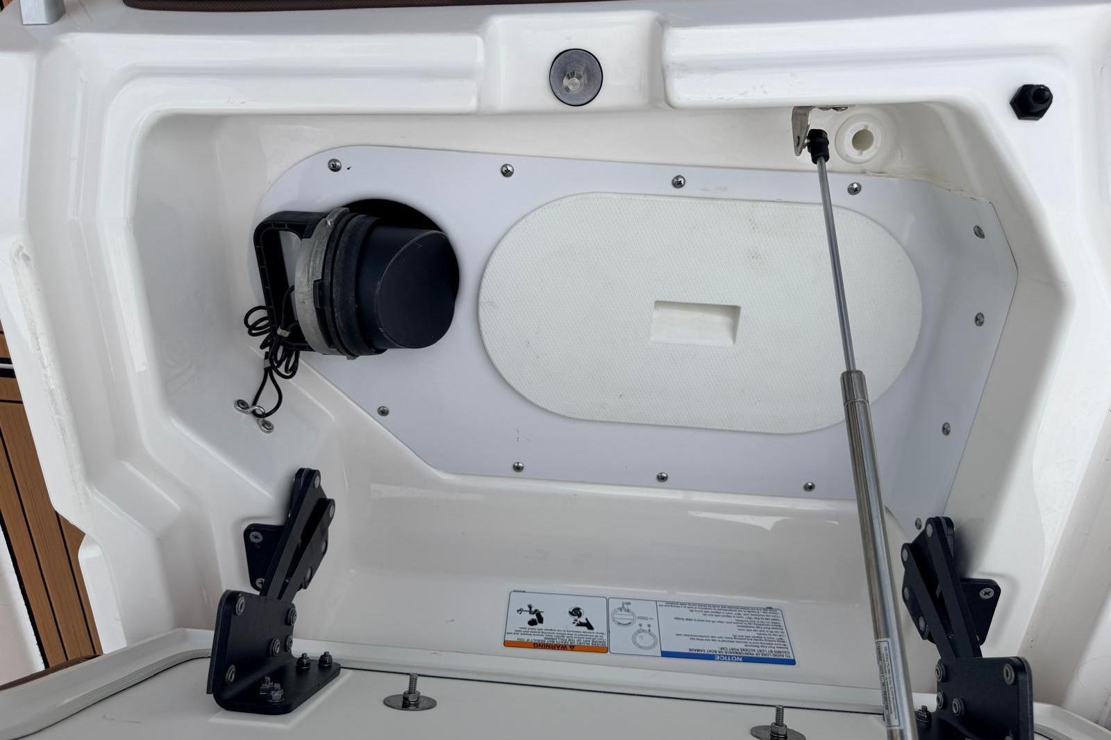 2024 Yamaha Boats 275SD storage compartment with hydraulic lift and secure latch system.