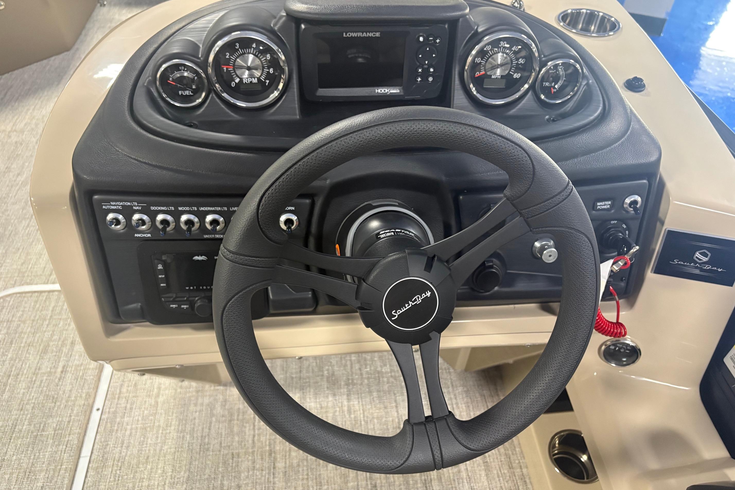 Steering console of 2026 South Bay S224RS boat with gauges and controls.