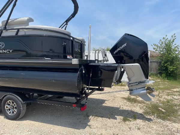2023 Regency 250 LE3 pontoon boat with Mercury outboard motor on trailer.