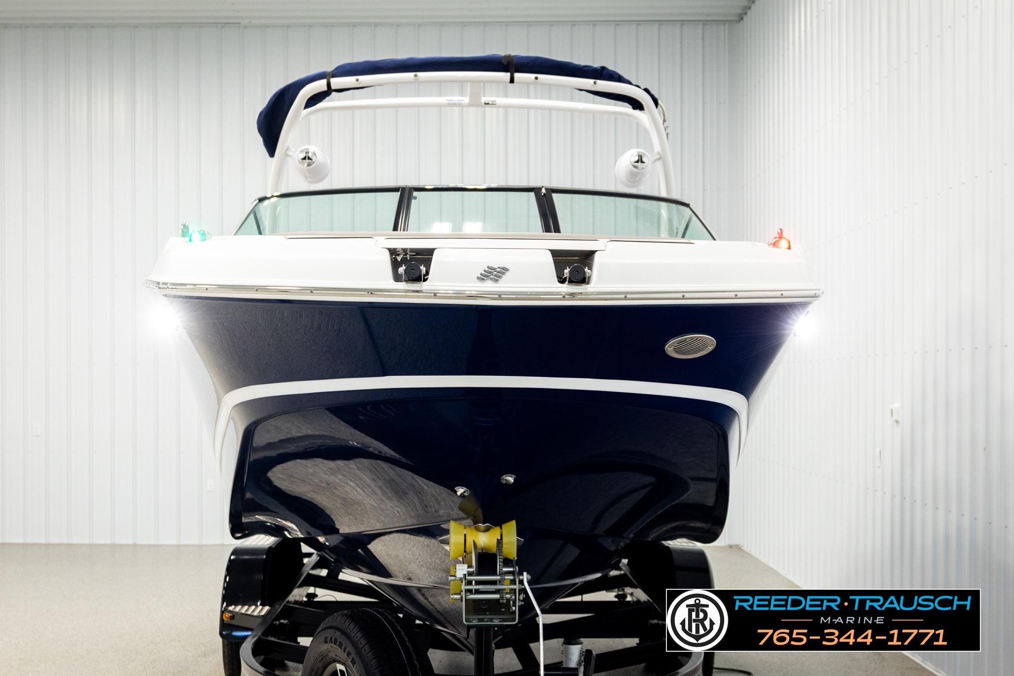 2024 FOURWINNS HD5 Surf boat in showroom, front view, with trailer.