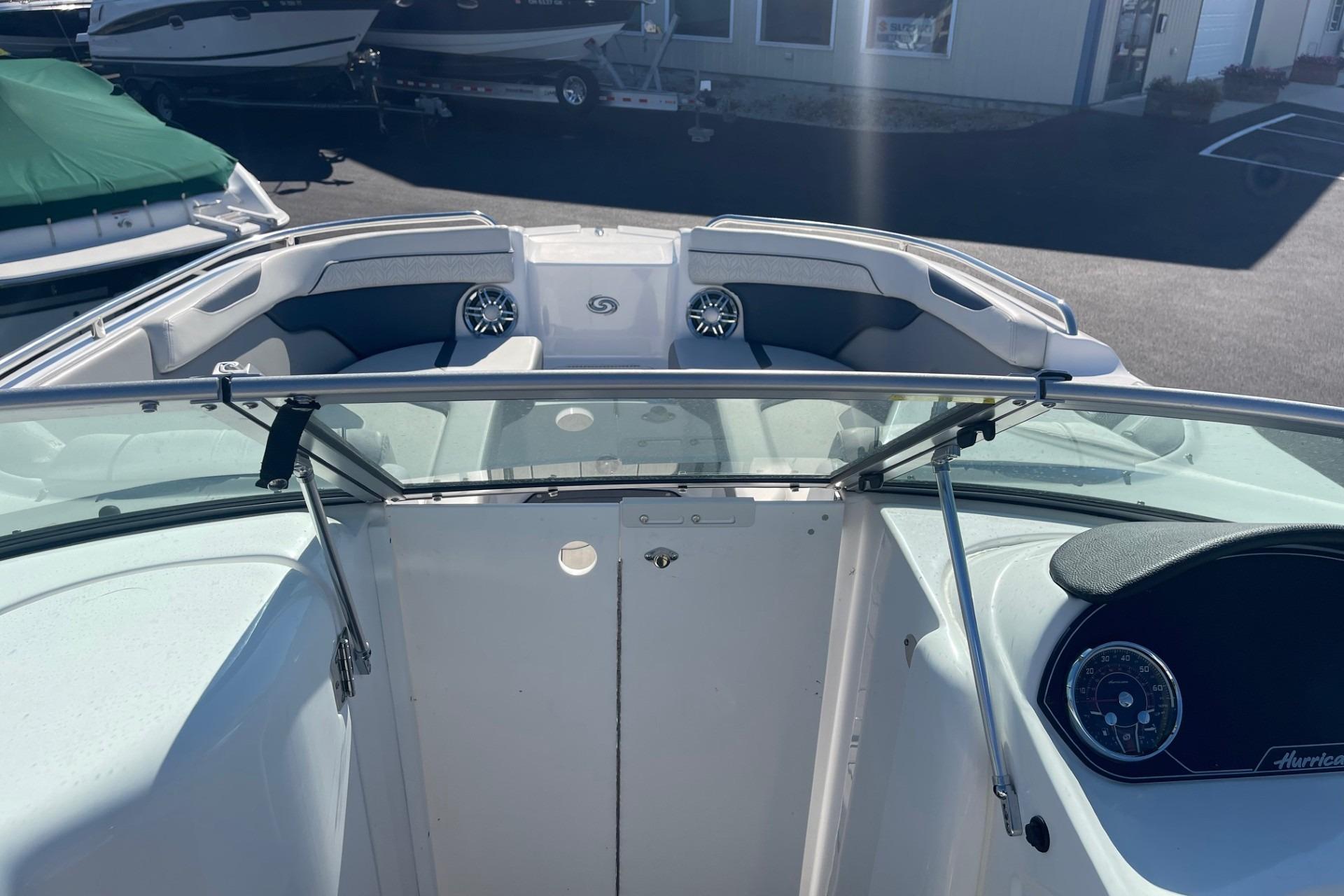 2023 Hurricane SunDeck 2400 OB boat interior with seating and dashboard view.