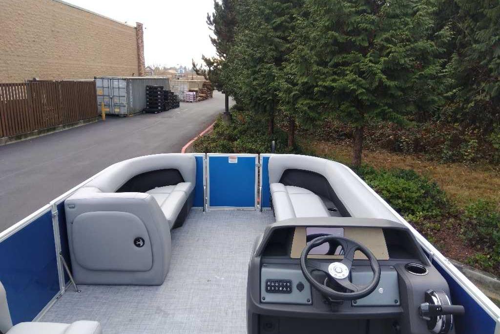 2026 Sun Tracker Party Barge 18 DLX pontoon boat with spacious seating and modern helm.