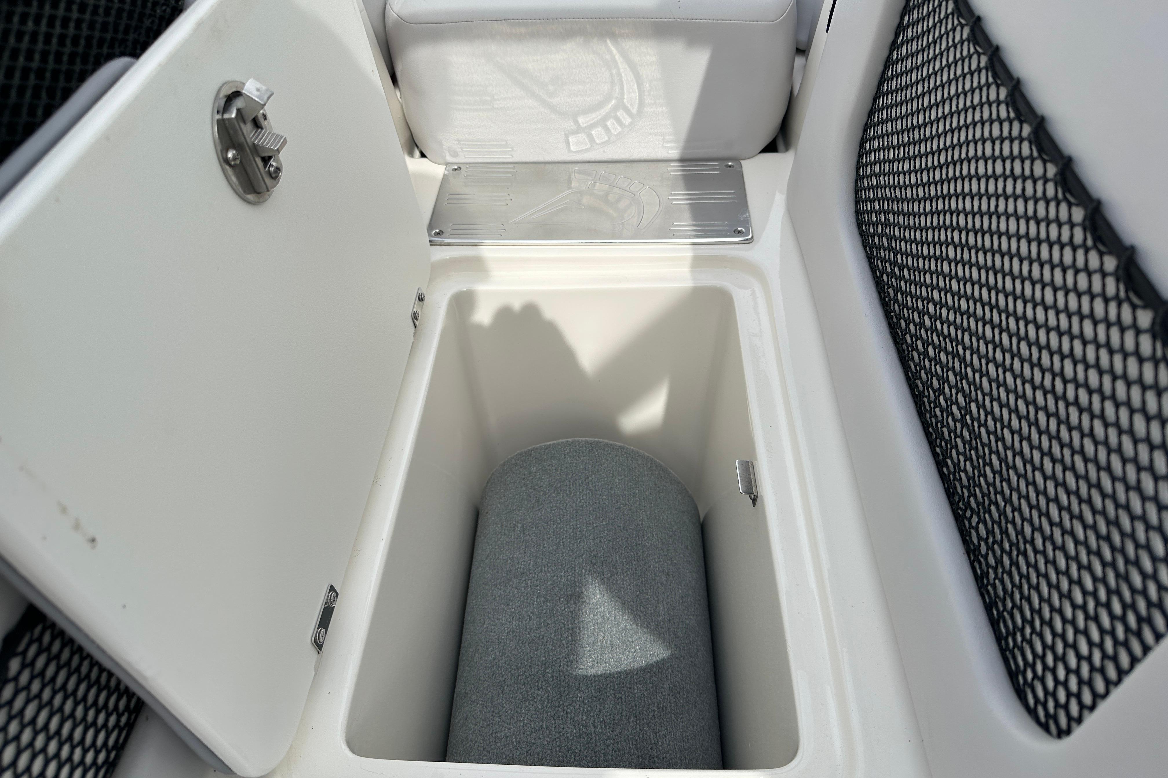 Storage compartment in a 2008 Centurion Enzo SV240 boat, featuring a cushioned interior.