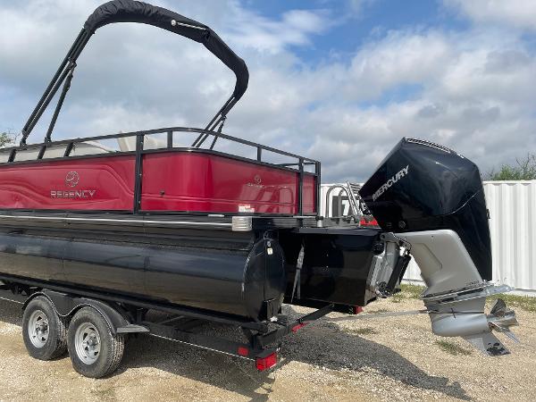 2023 Regency 250DL3 pontoon boat with Mercury outboard motor on a trailer.