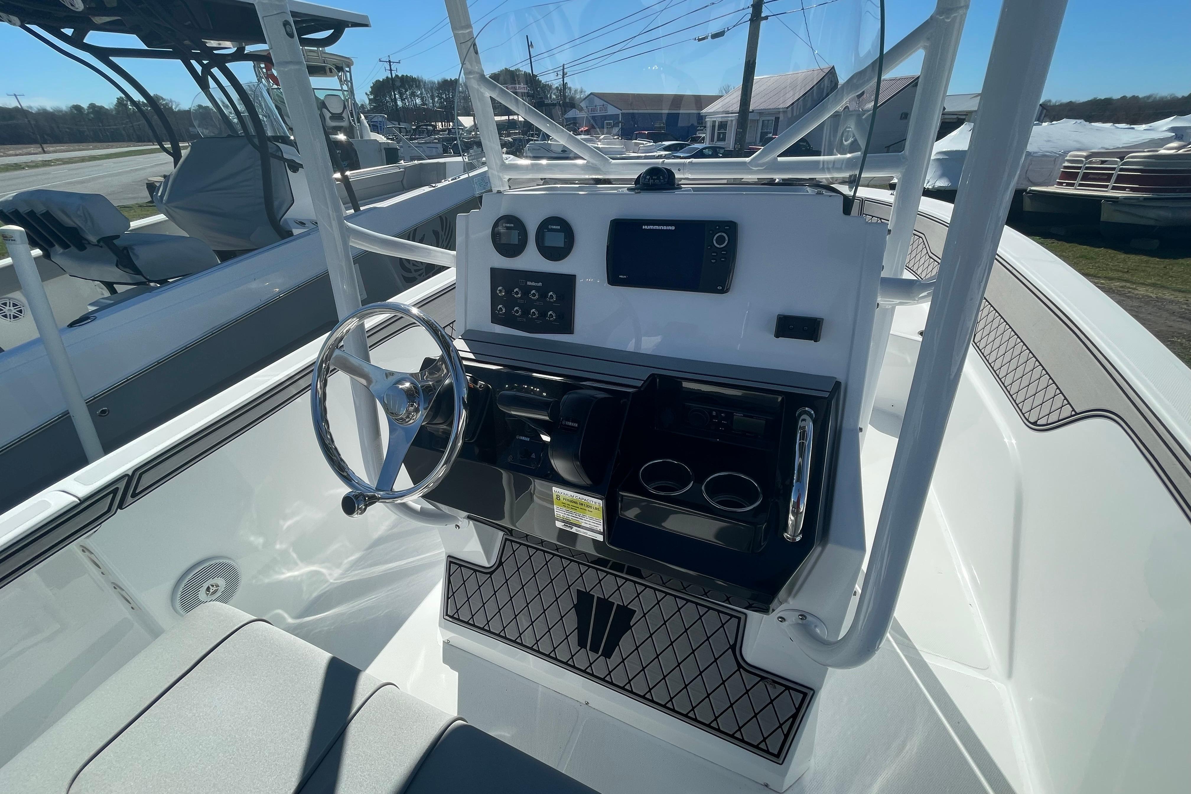 2022 Wellcraft 202 Fisherman boat console with steering wheel and navigation controls.