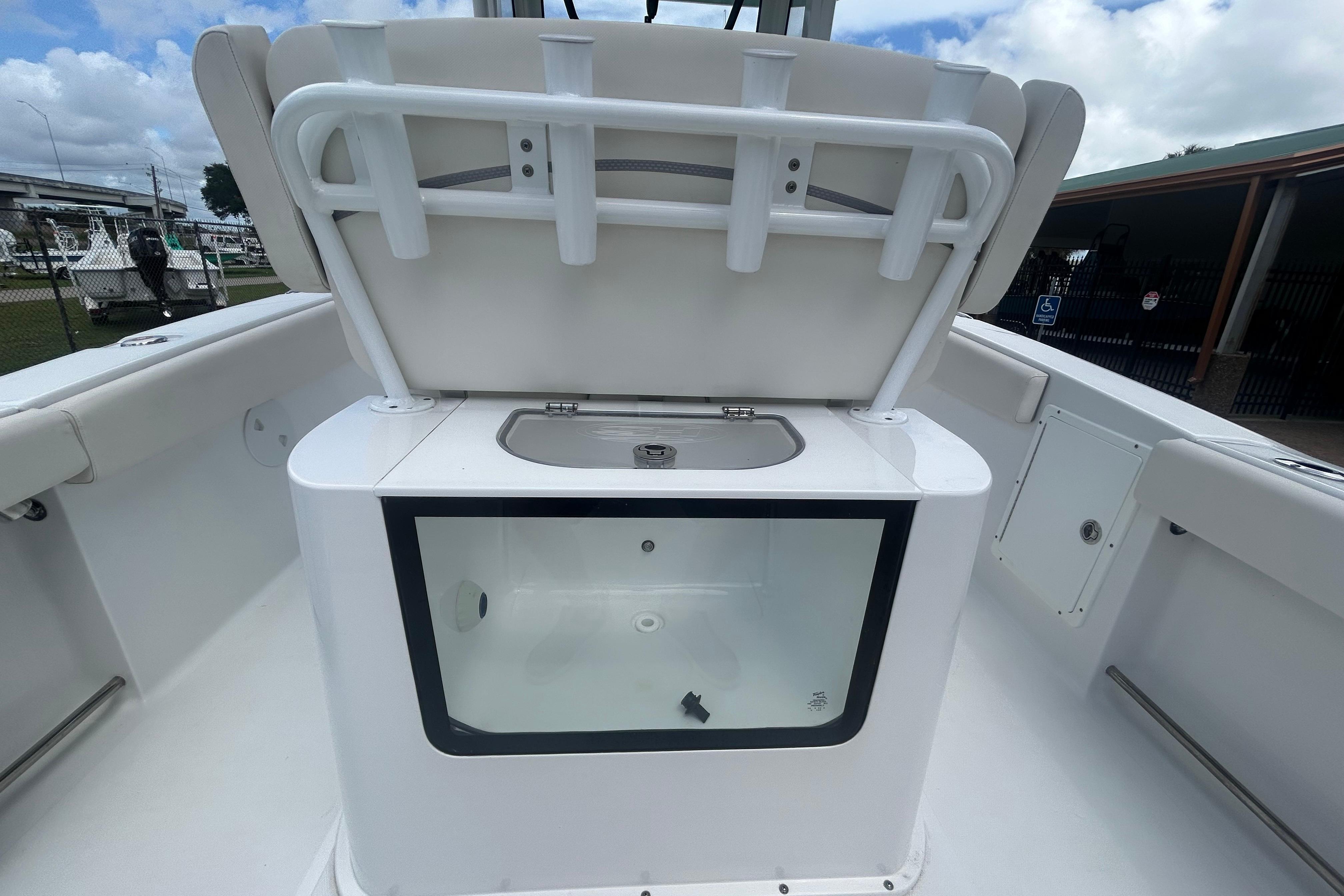 2023 Sea Hunt Gamefish 27 Coffin Box with open storage compartment, showcasing sleek design.