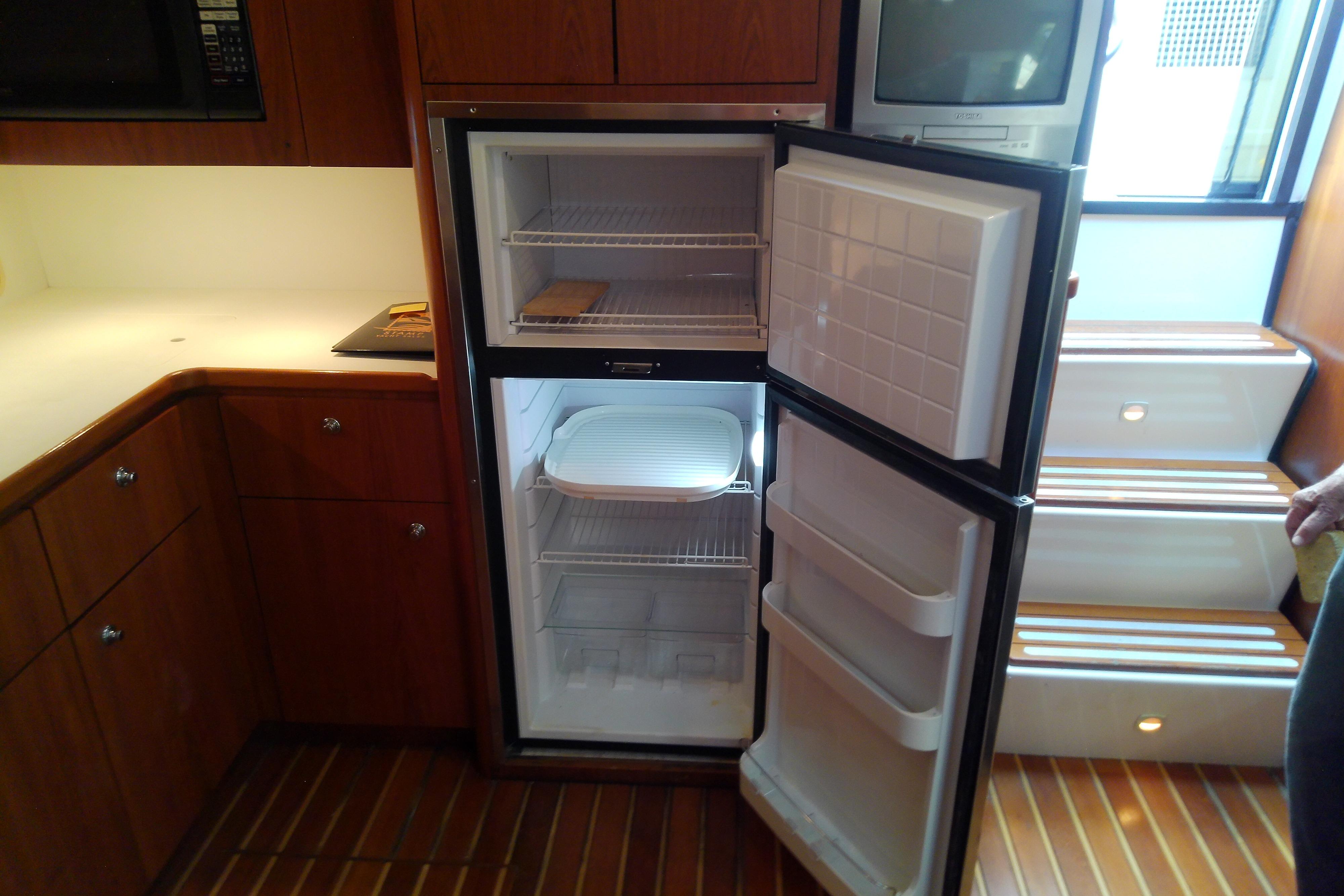 Open refrigerator in the galley of a 2000 Tiara Yachts 4100 Open.