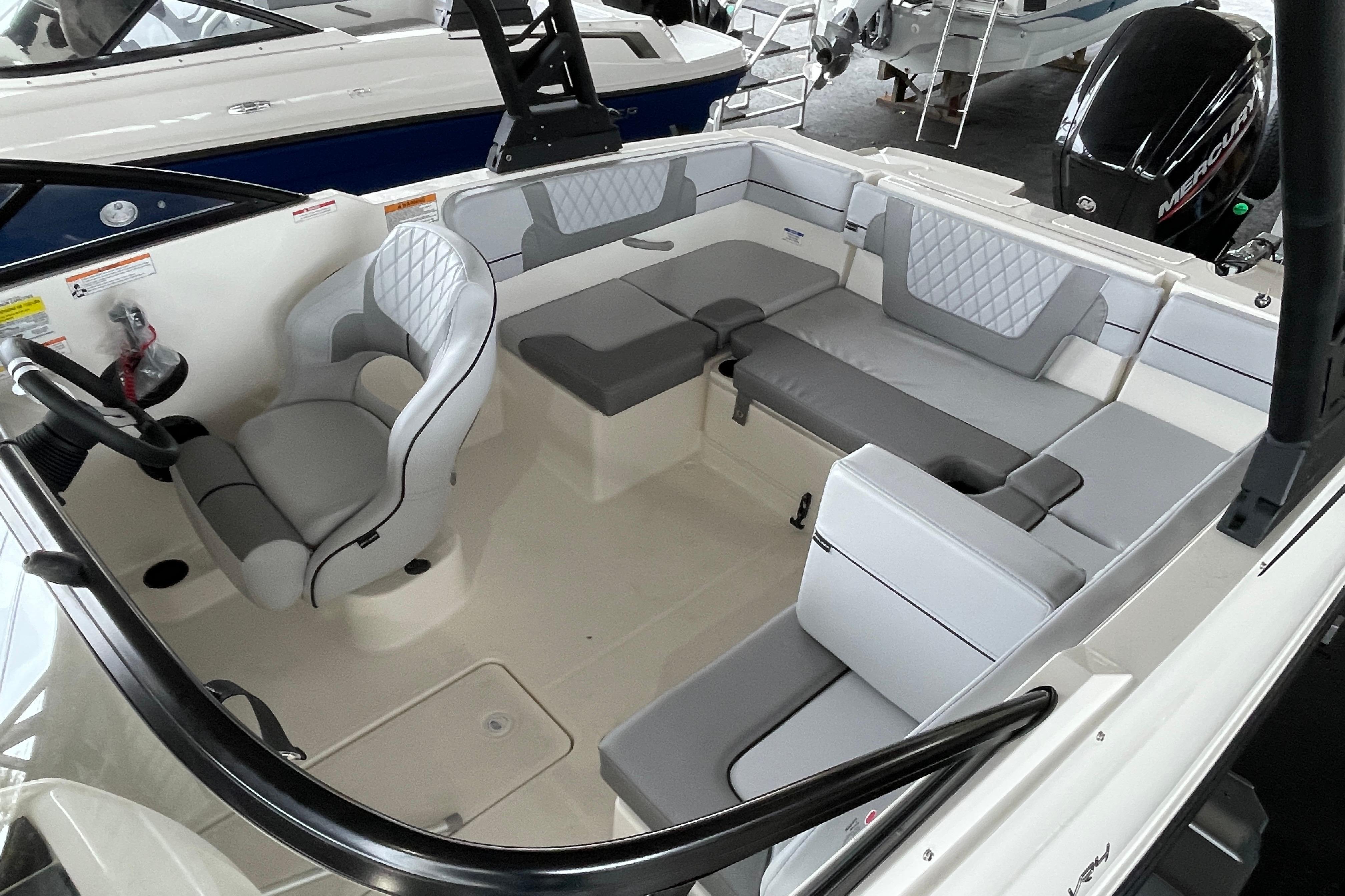 2026 Bayliner VR4 Bowrider OB interior with gray seating and steering wheel.