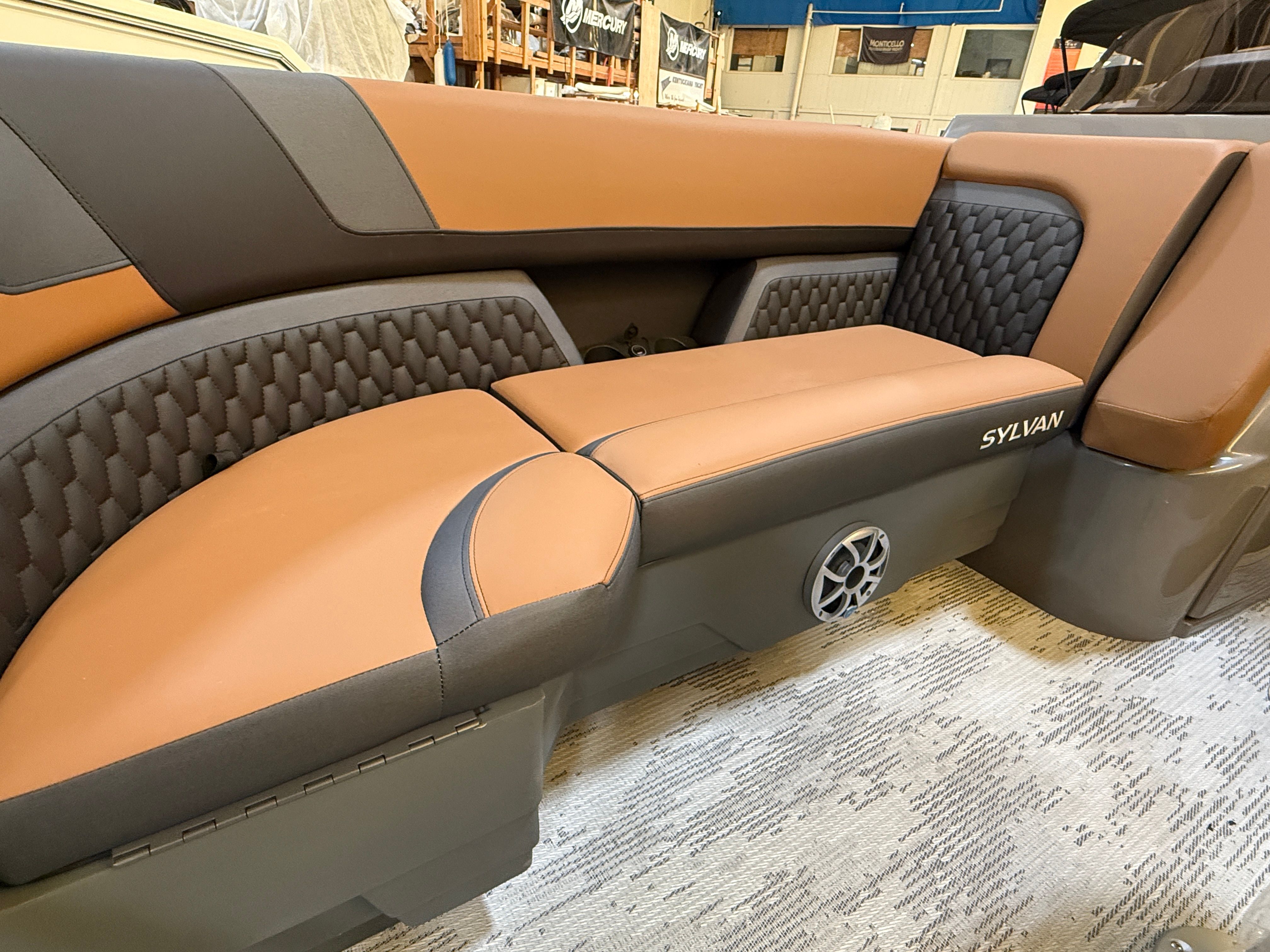 The 2026 Sylvan L3 ULZ DH interior features stylish, cushioned seating in brown and gray.