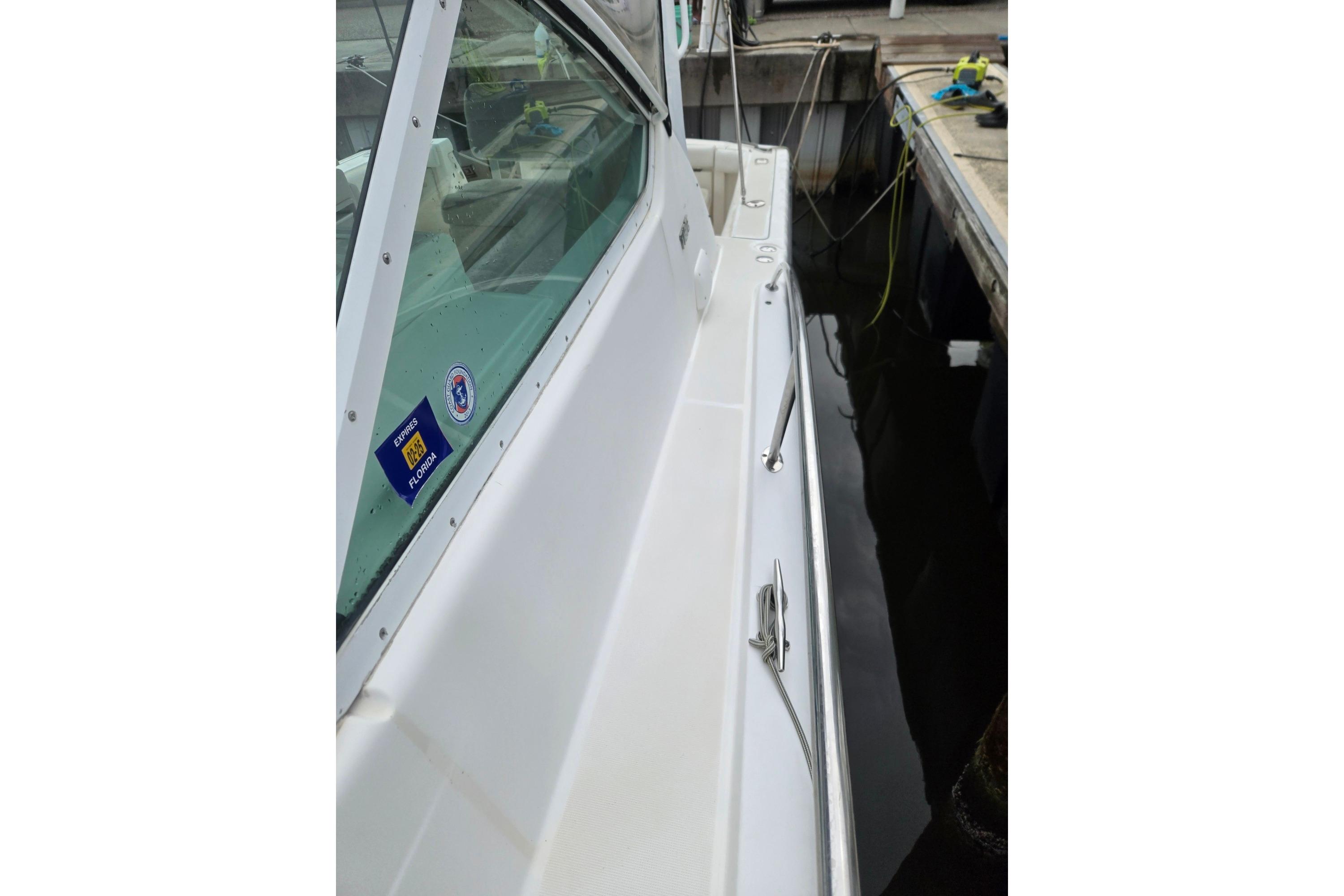 2002 Tiara Yachts 3500 Open docked, showcasing sleek white exterior and window decals.