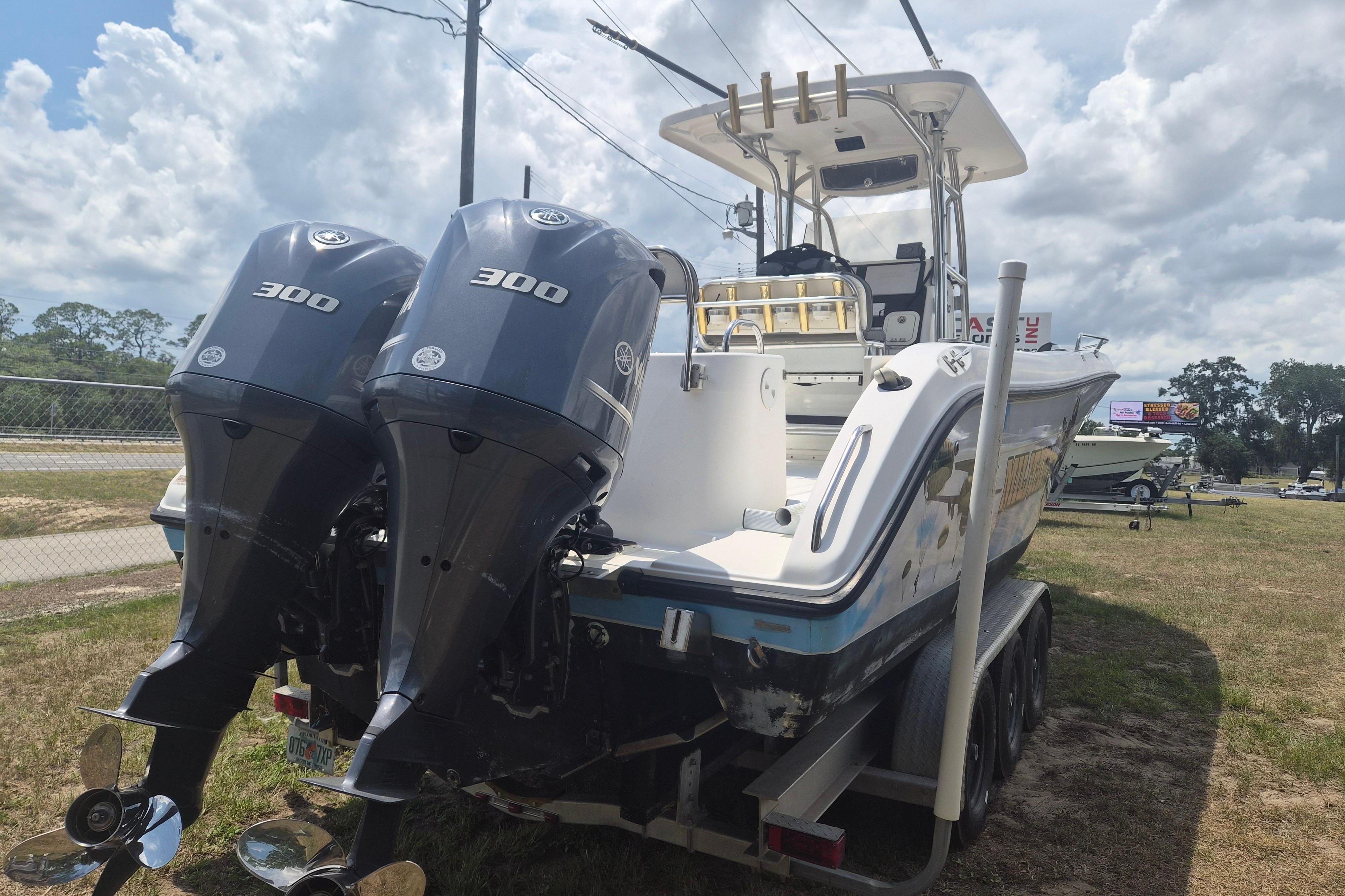 2006 Century 2900 Center Console boat with dual 300 horsepower engines on a trailer.