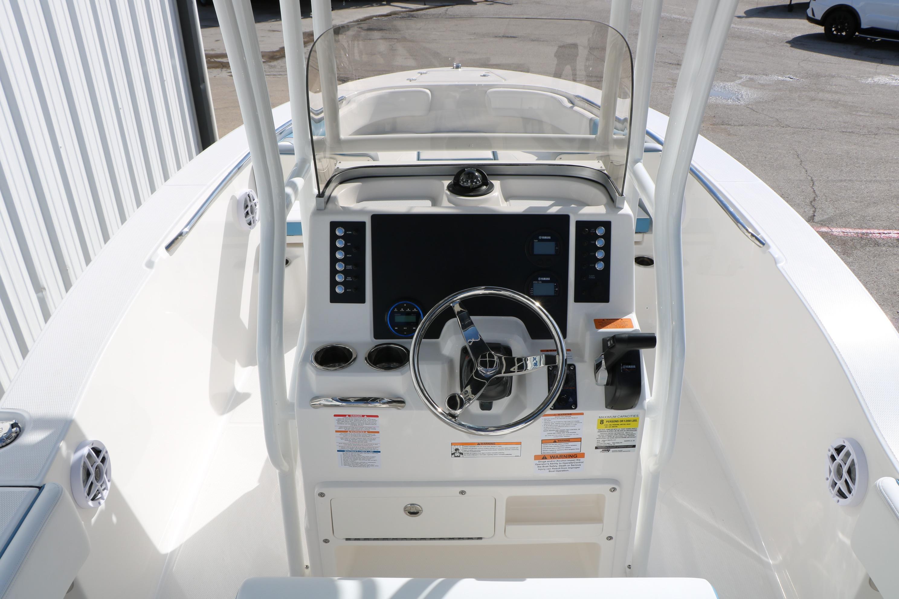 2026 Robalo R200 Center Console boat interior with steering wheel and control panel.