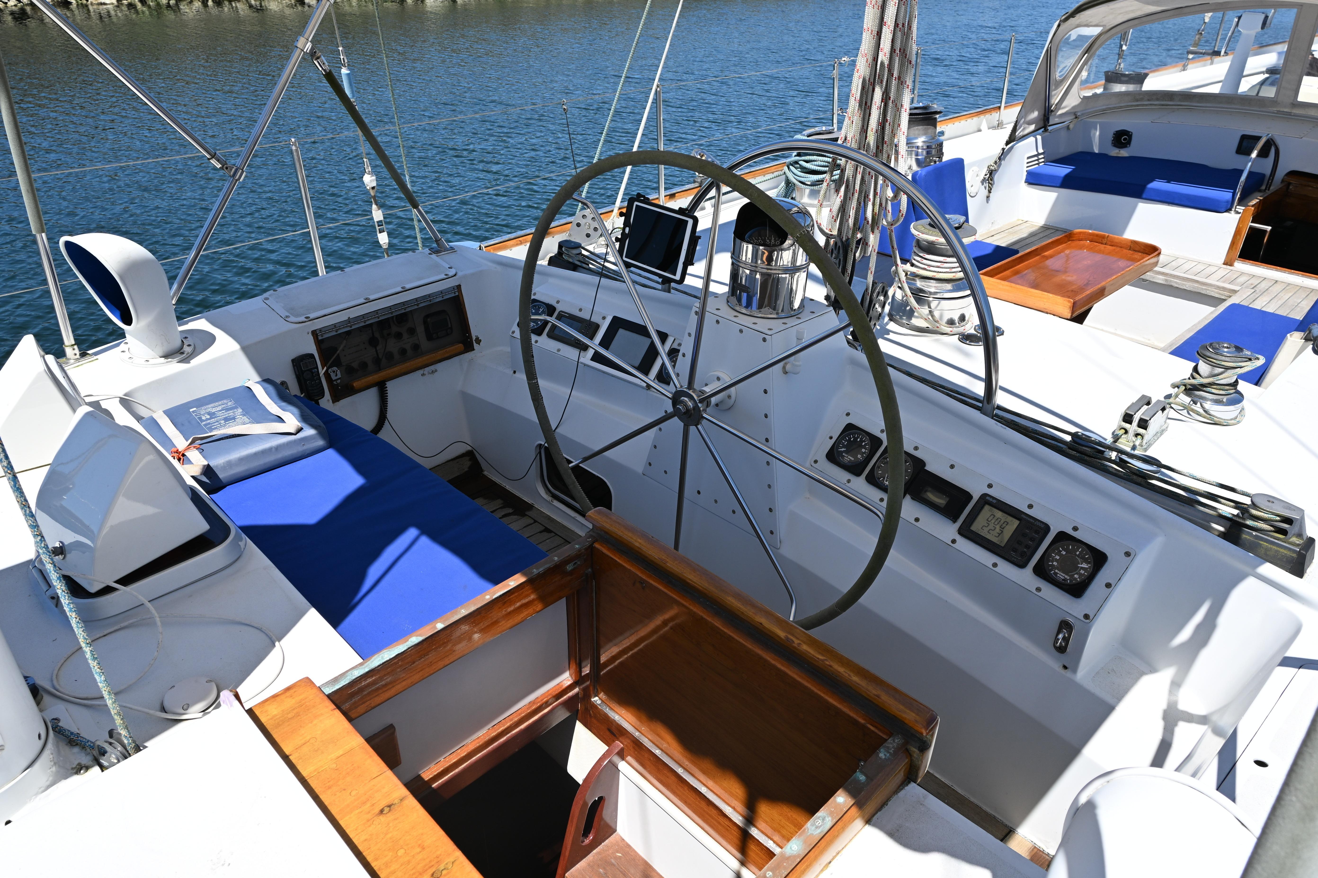 Cockpit of 1968 Abeking & Rasmussen Tripp 74 yacht with steering wheel and navigation instruments.