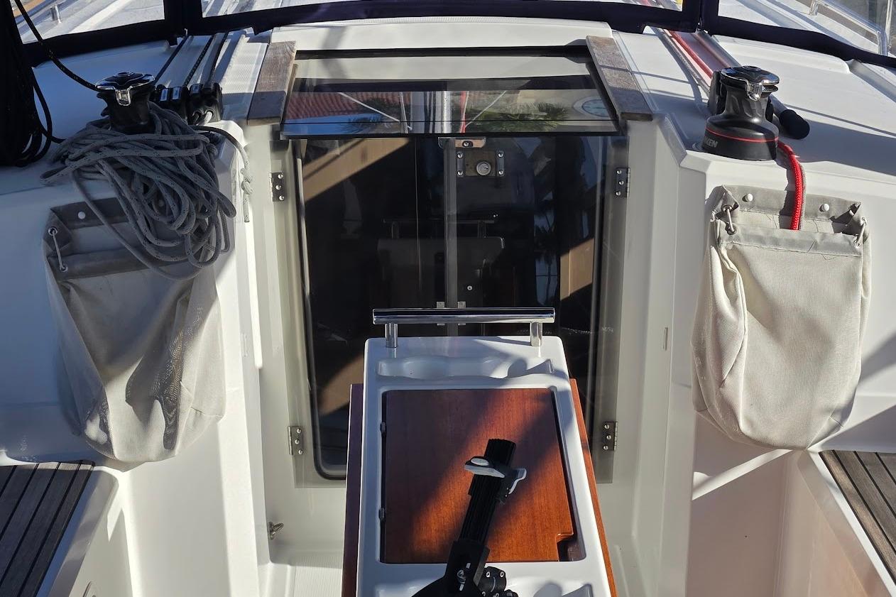 2023 Beneteau Oceanis 38.1 cockpit with winches, ropes, and storage bags.