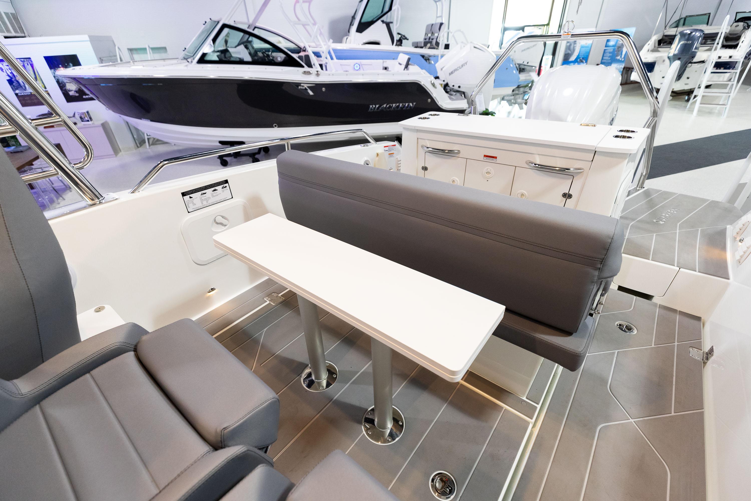 2024 Quarken 27 T-Top V2 boat interior with seating and table, showcasing modern design.