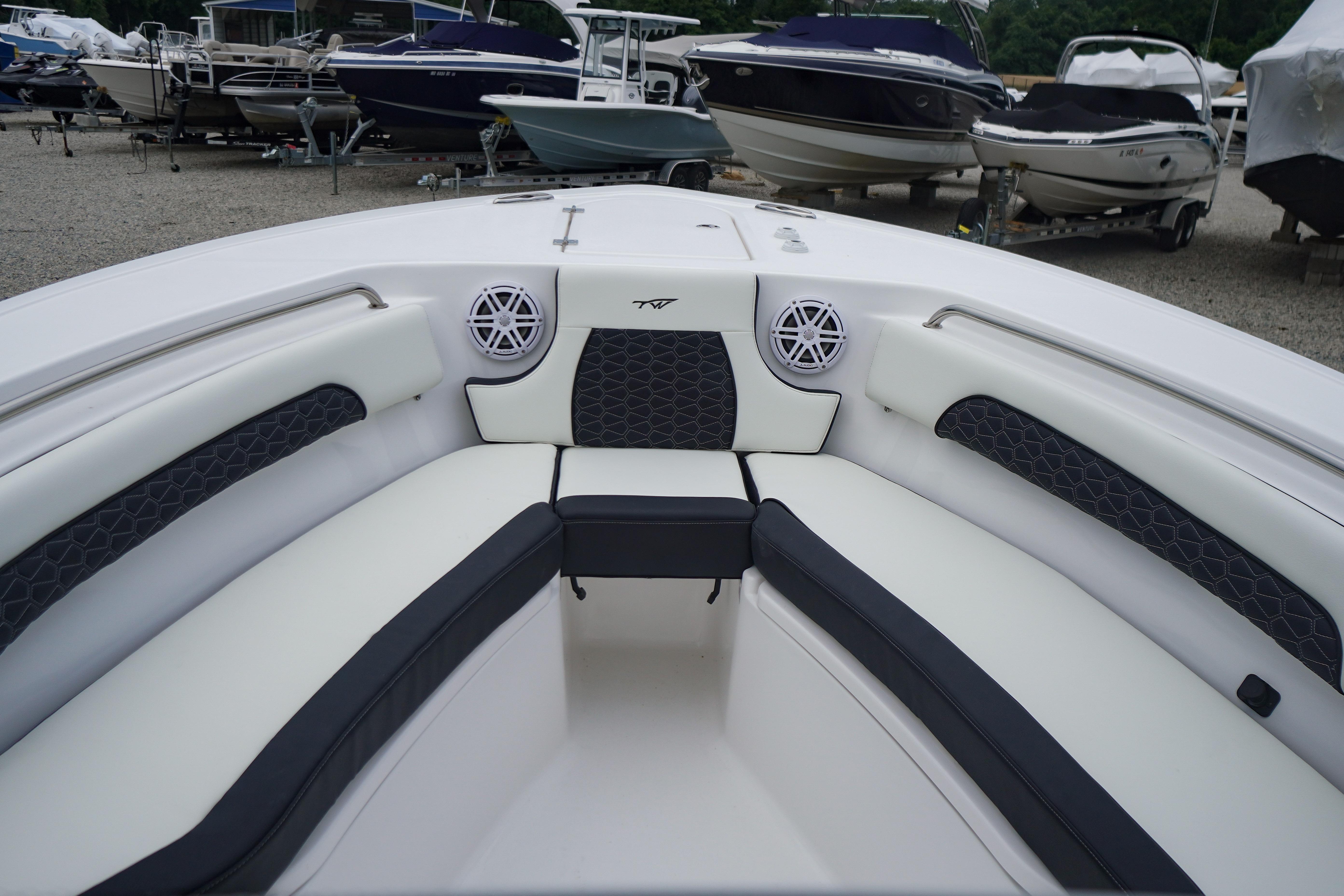 2026 Tidewater 232 SS boat interior with cushioned seating and speakers.