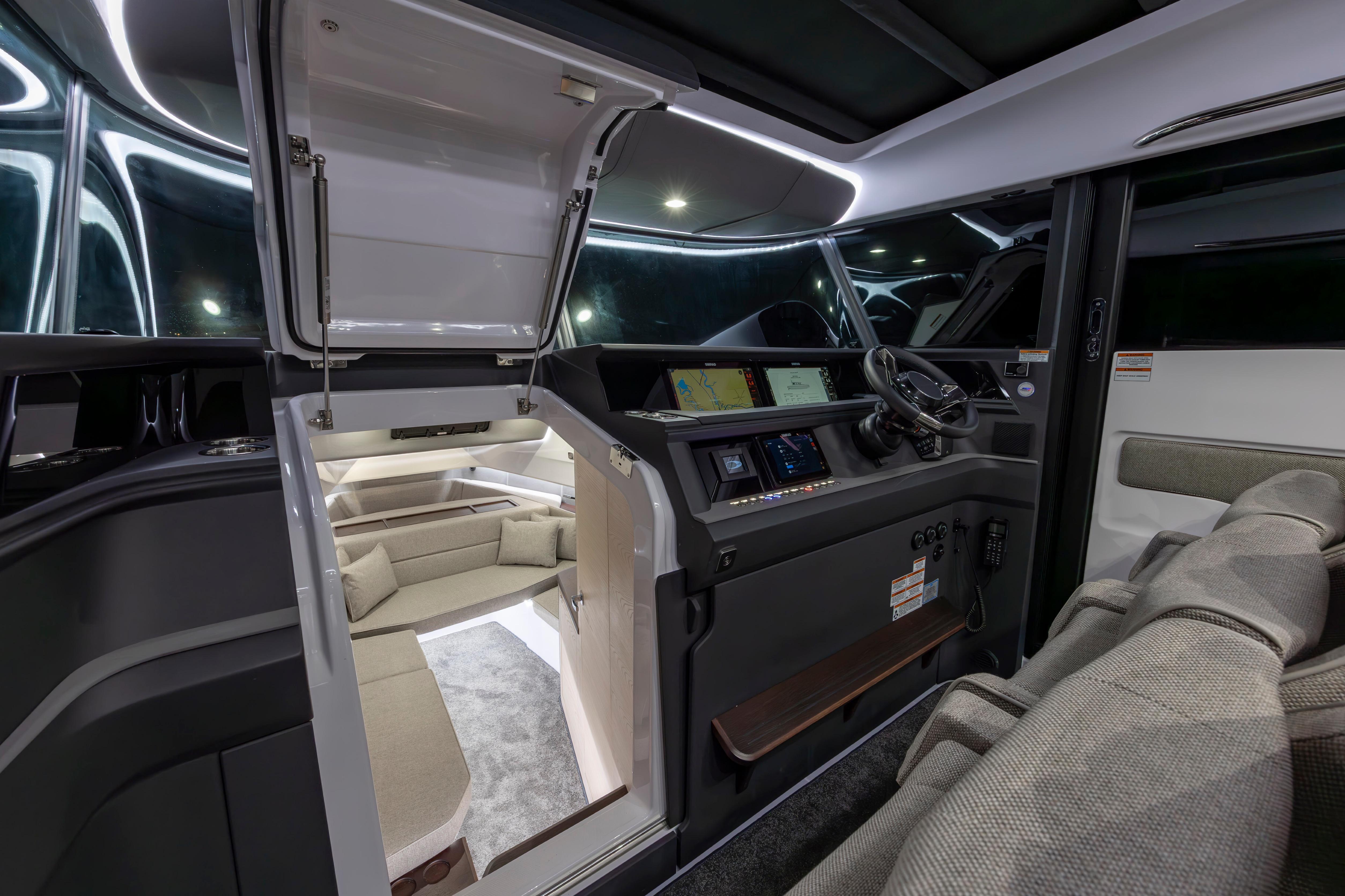 Luxurious interior of 2027 Axopar 45 XC Cross Cabin with modern helm and seating area.