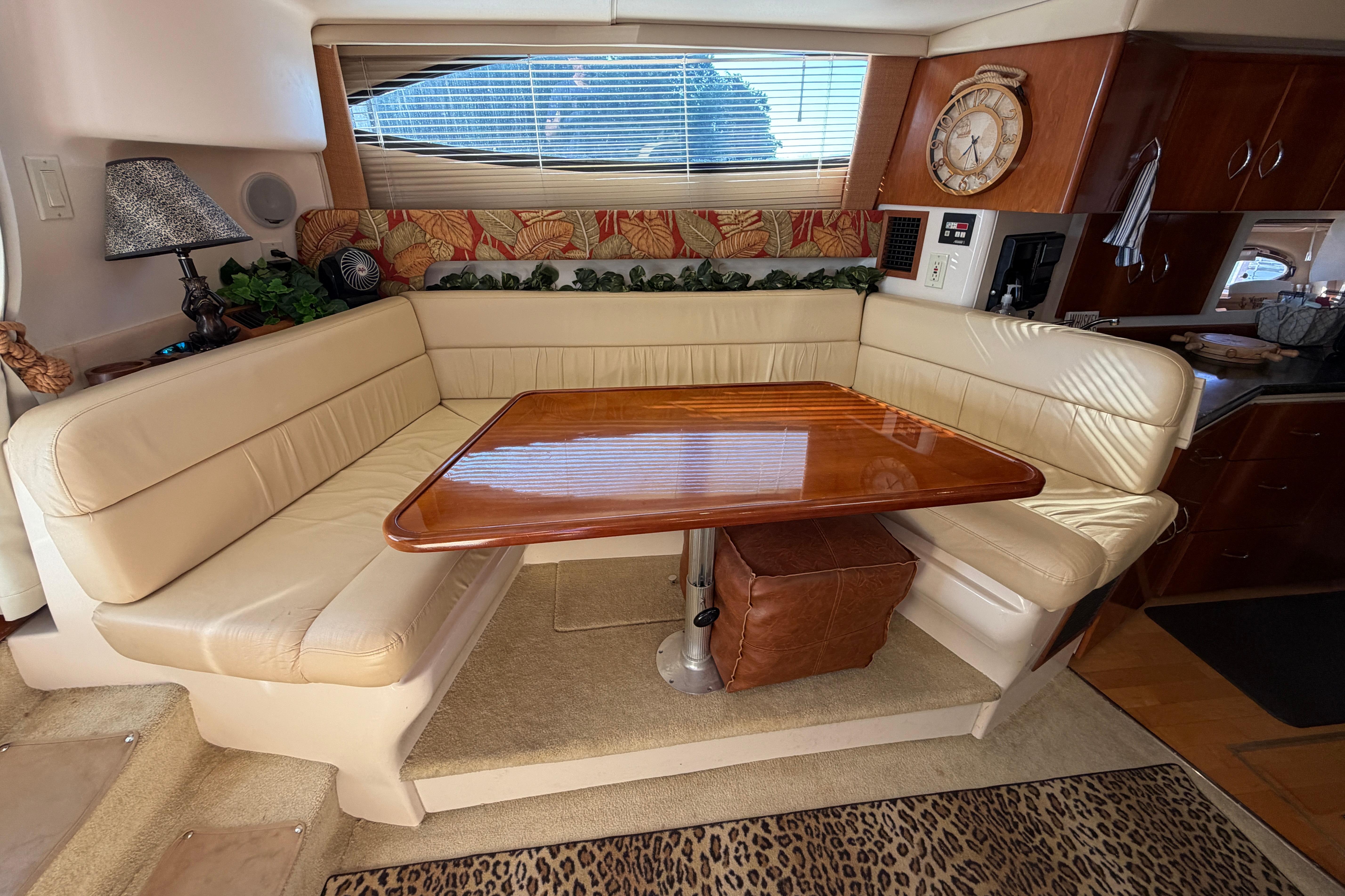 Luxurious interior of 2003 Carver 350 Mariner yacht with elegant dining area.