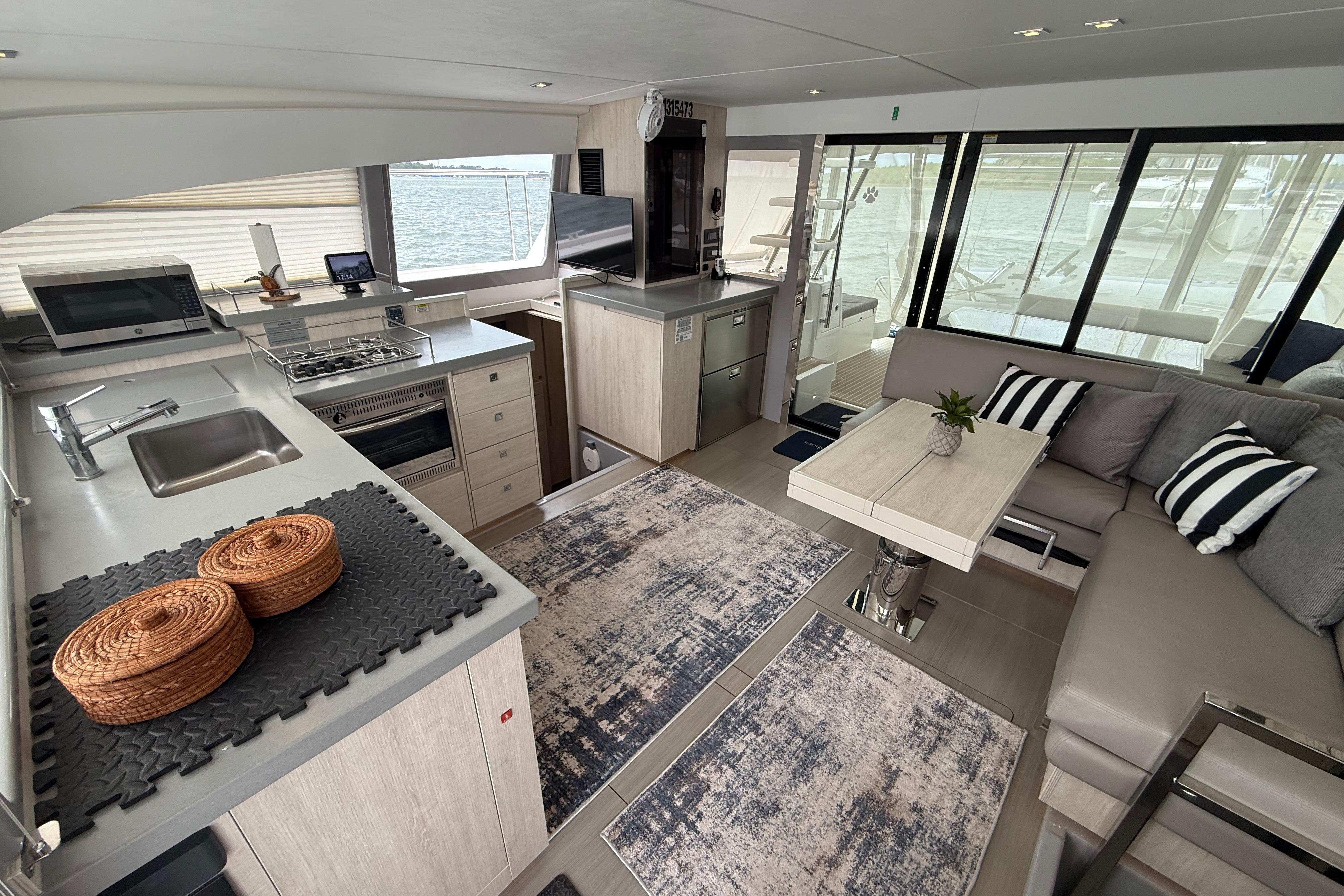 Interior of 2021 Leopard 43 Powercat yacht with modern kitchen and cozy seating area.