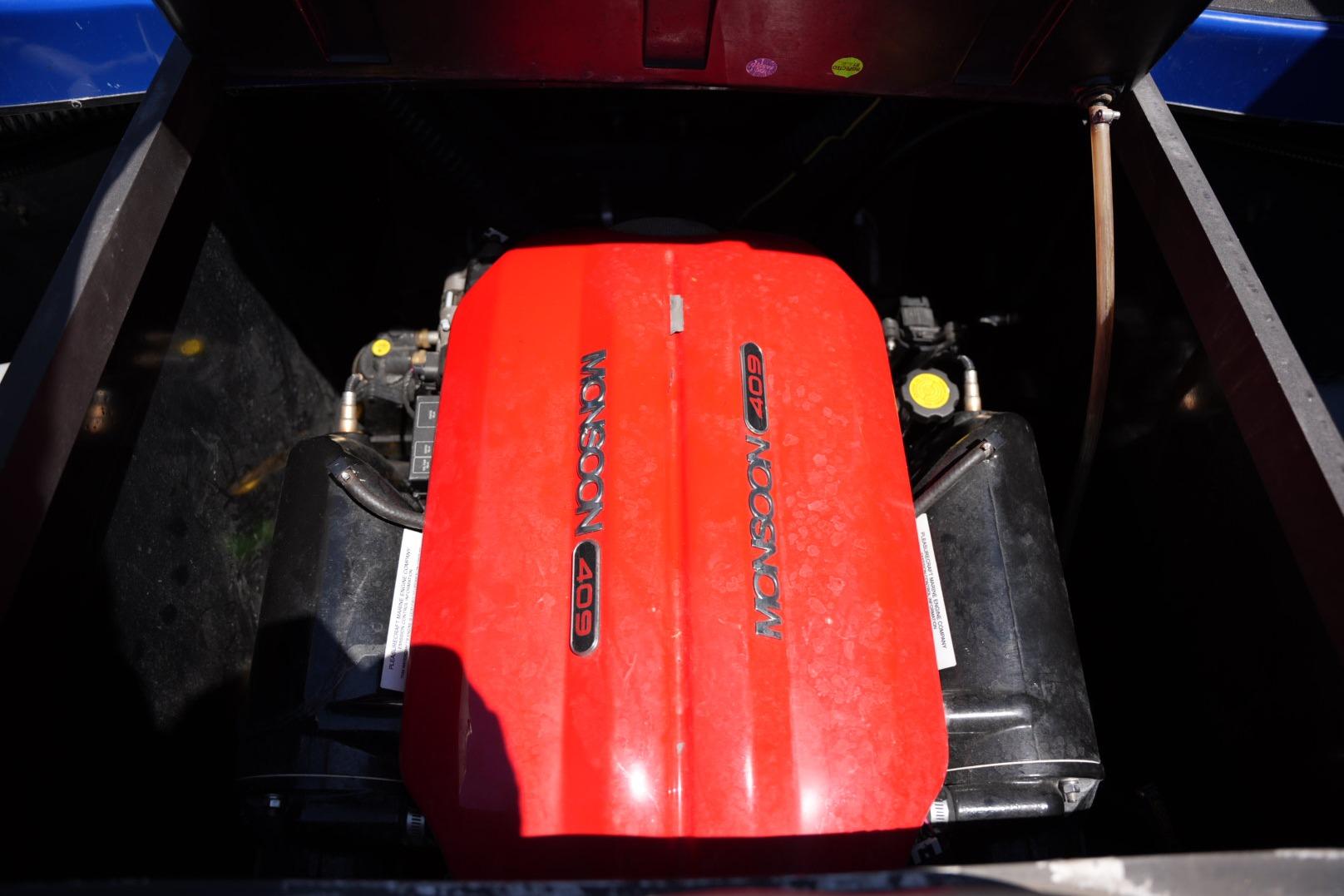 Red Monsoon 409 engine in a 2015 Axis A24 boat, partially enclosed.