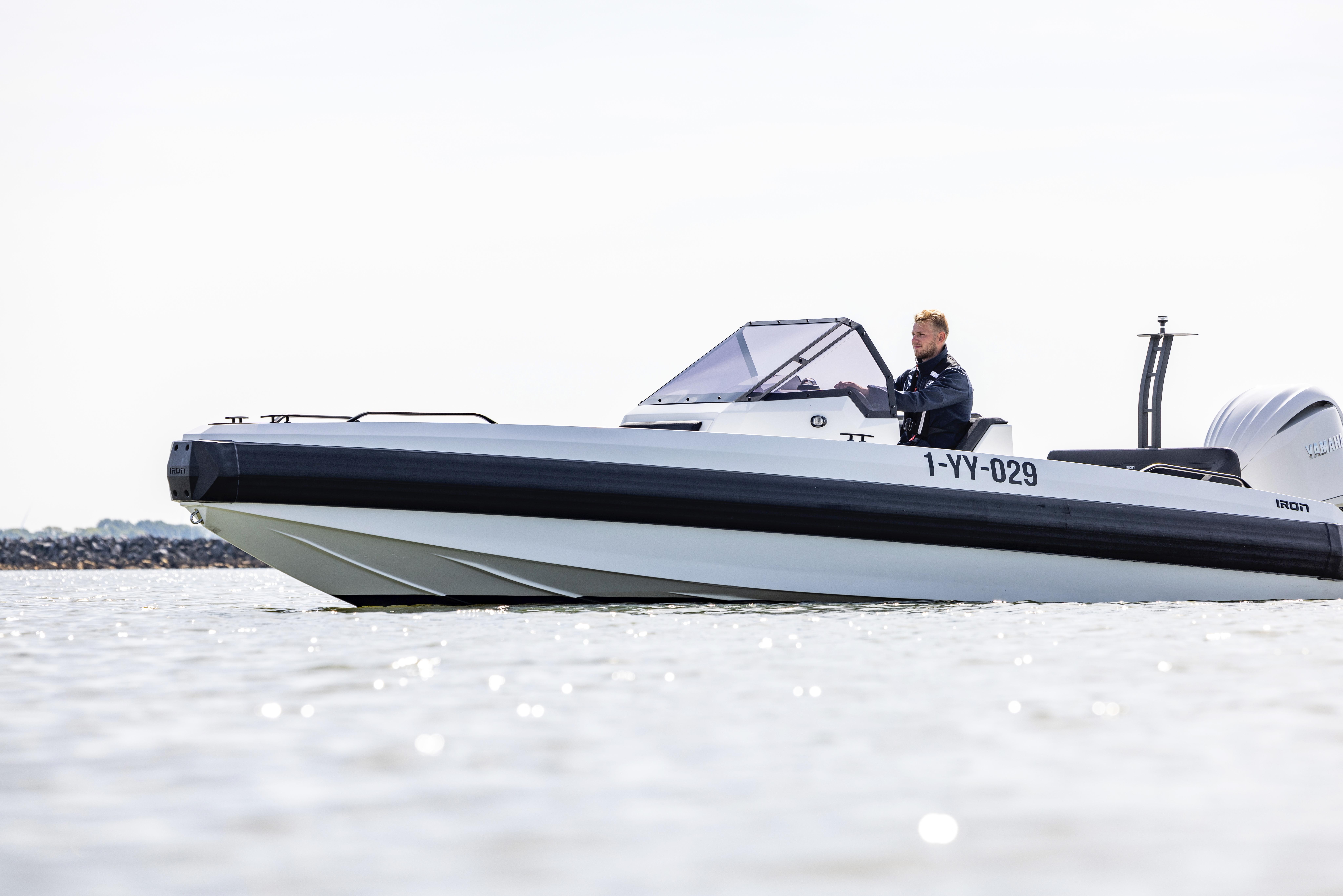 2022 Iron 707 boat on water, side view with driver, sleek design.