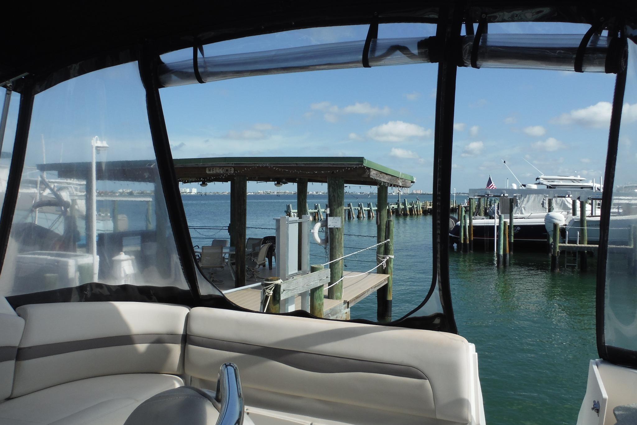 2005 Chaparral Signature 350 yacht interior with marina view, clear skies, and docked boats.