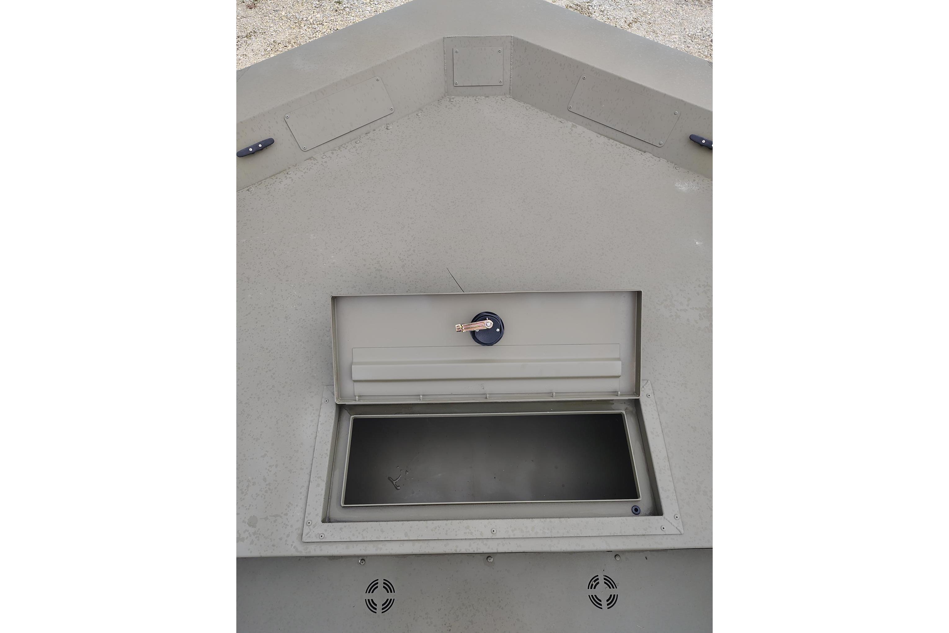Storage compartment of 2025 Tracker Grizzly 1860 Utility boat, open with key inserted.