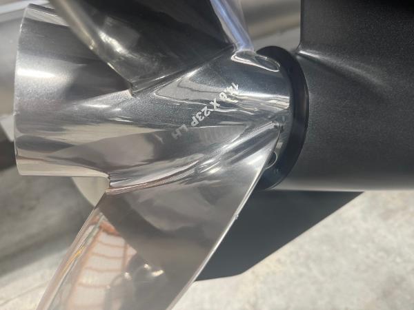 Close-up of a 2025 Manitou LX boat propeller, showcasing its sleek, metallic design.