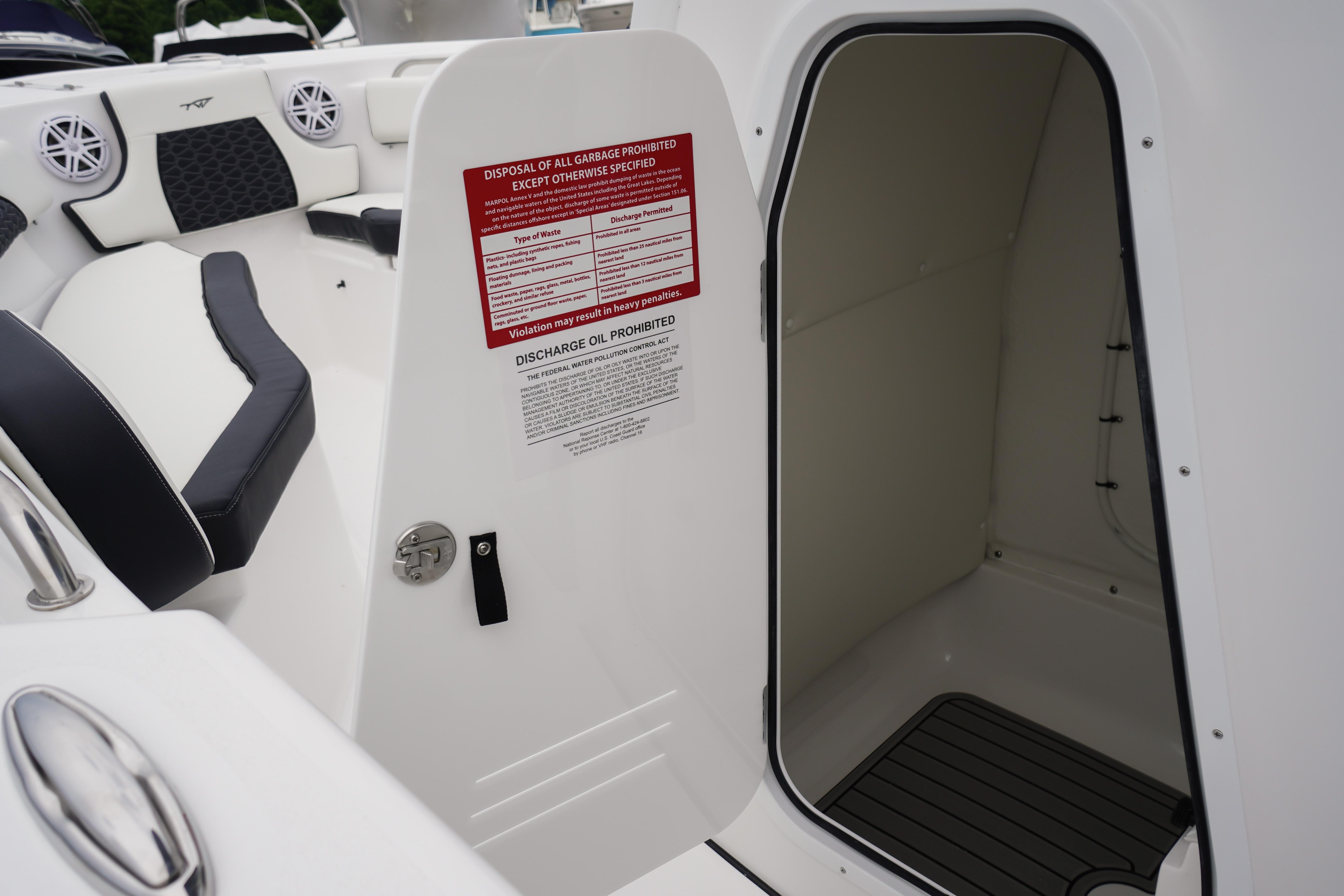 Interior view of a 2026 Tidewater 232 SS boat, featuring seating and storage compartment.