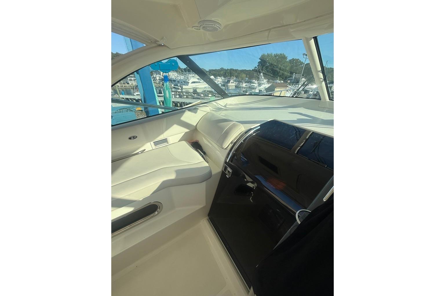 Interior view of 2010 Pursuit OS 375 Offshore boat, showcasing helm and seating area.