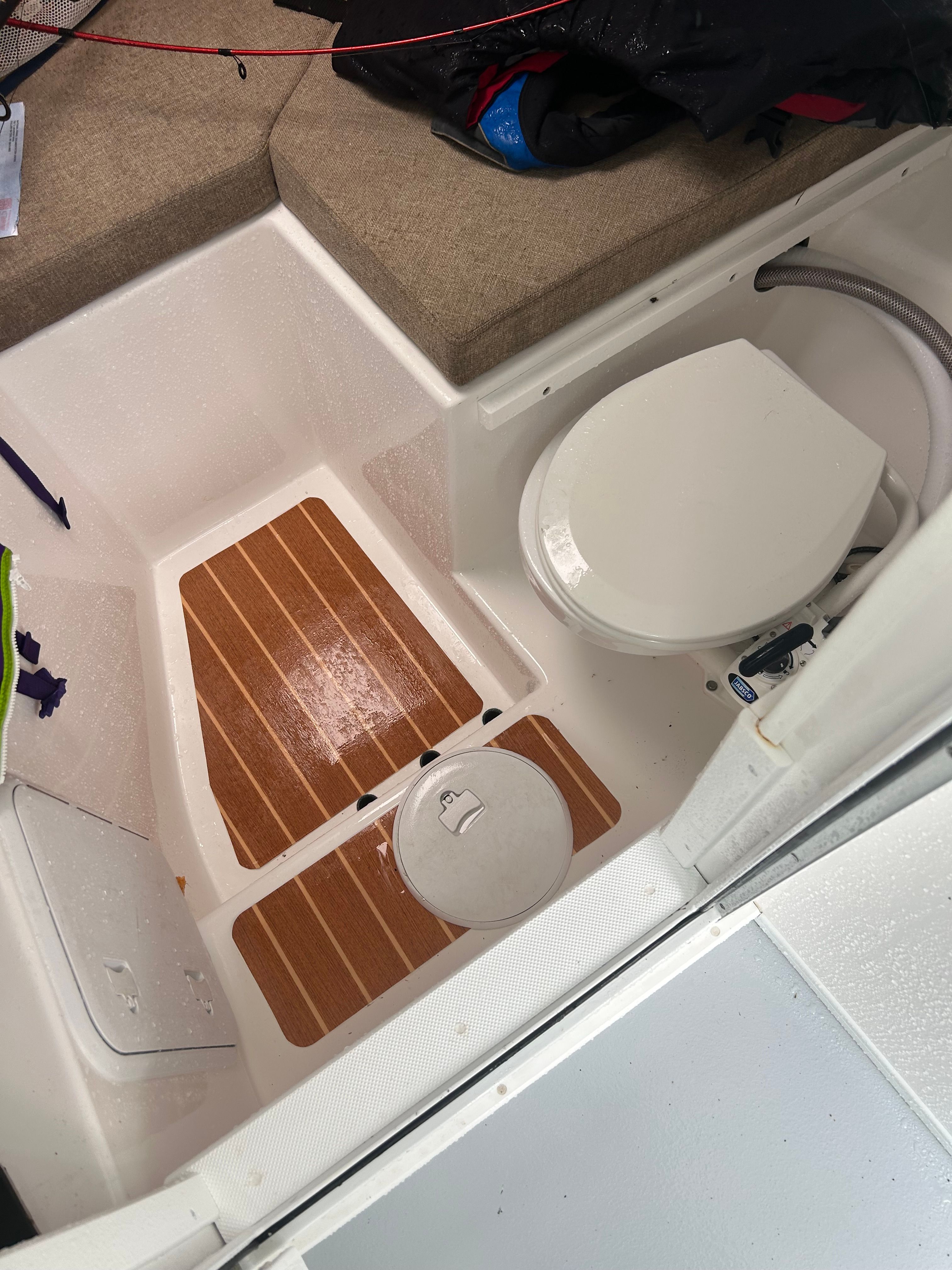 Interior of a 2019 Steiger Craft 28 Miami with a toilet and wood flooring.