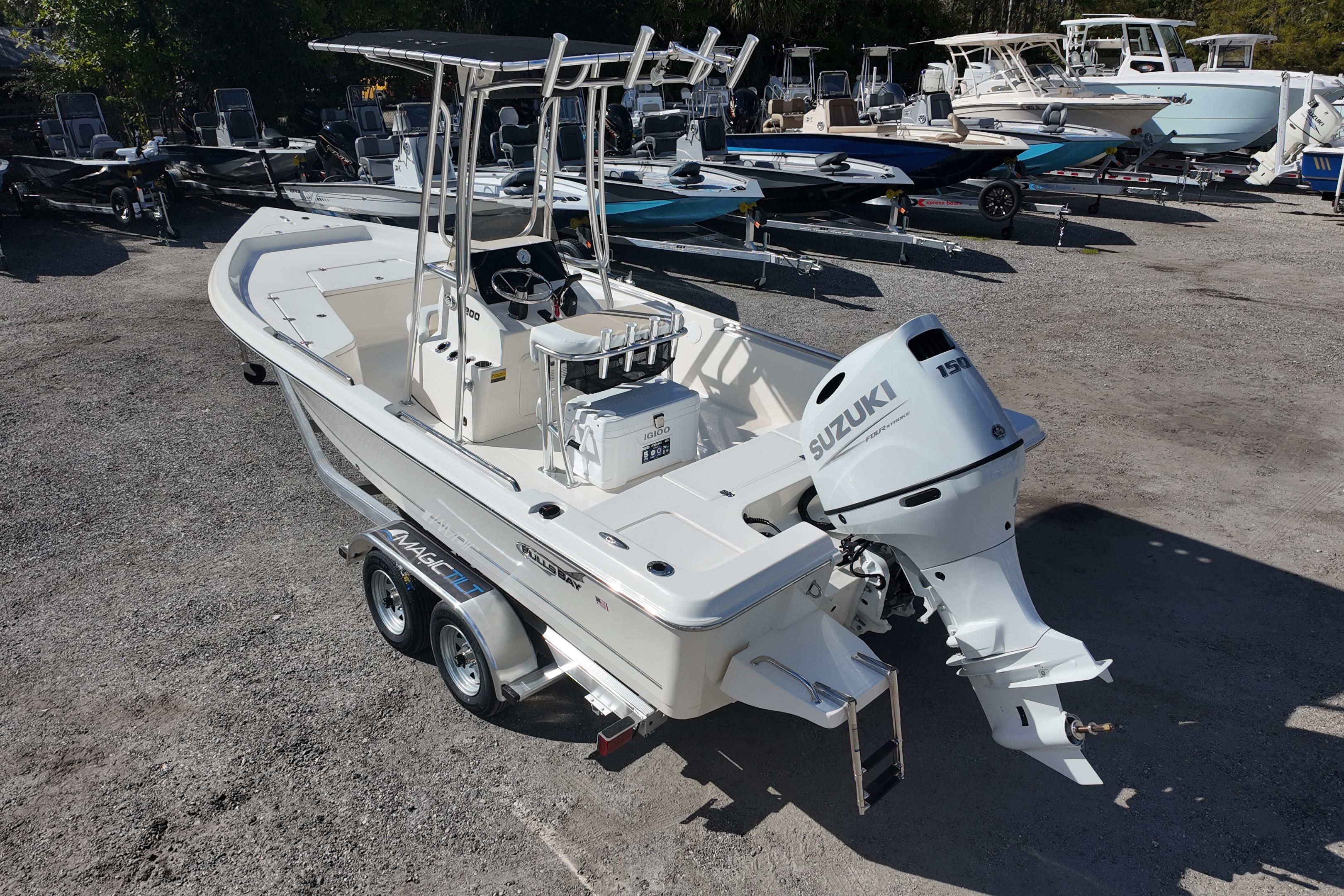 2026 Bulls Bay 2200 boat with Suzuki engine on trailer in a dealership lot.