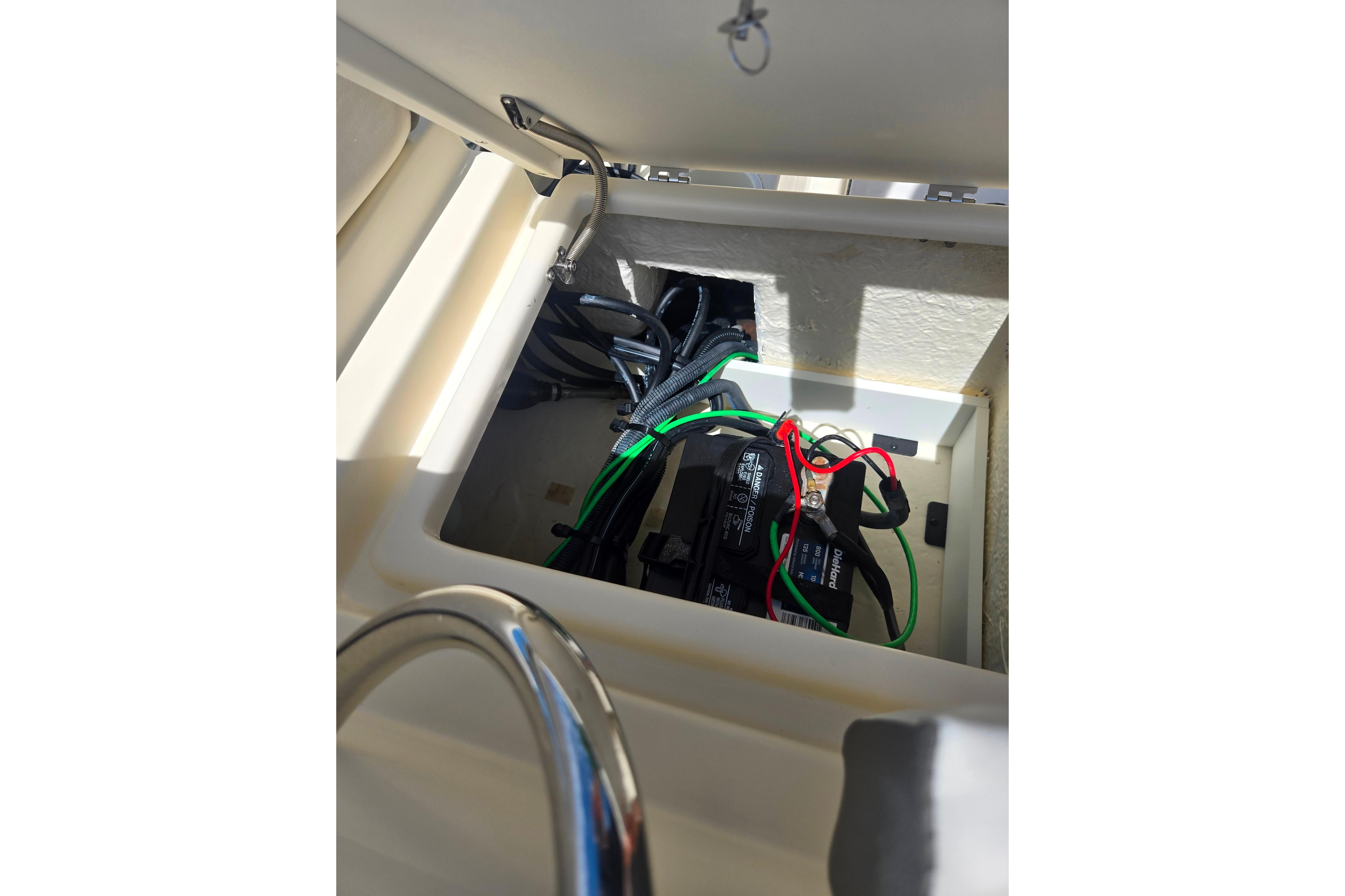 Battery compartment of a 2016 Key Largo 2000CC boat with visible wiring.