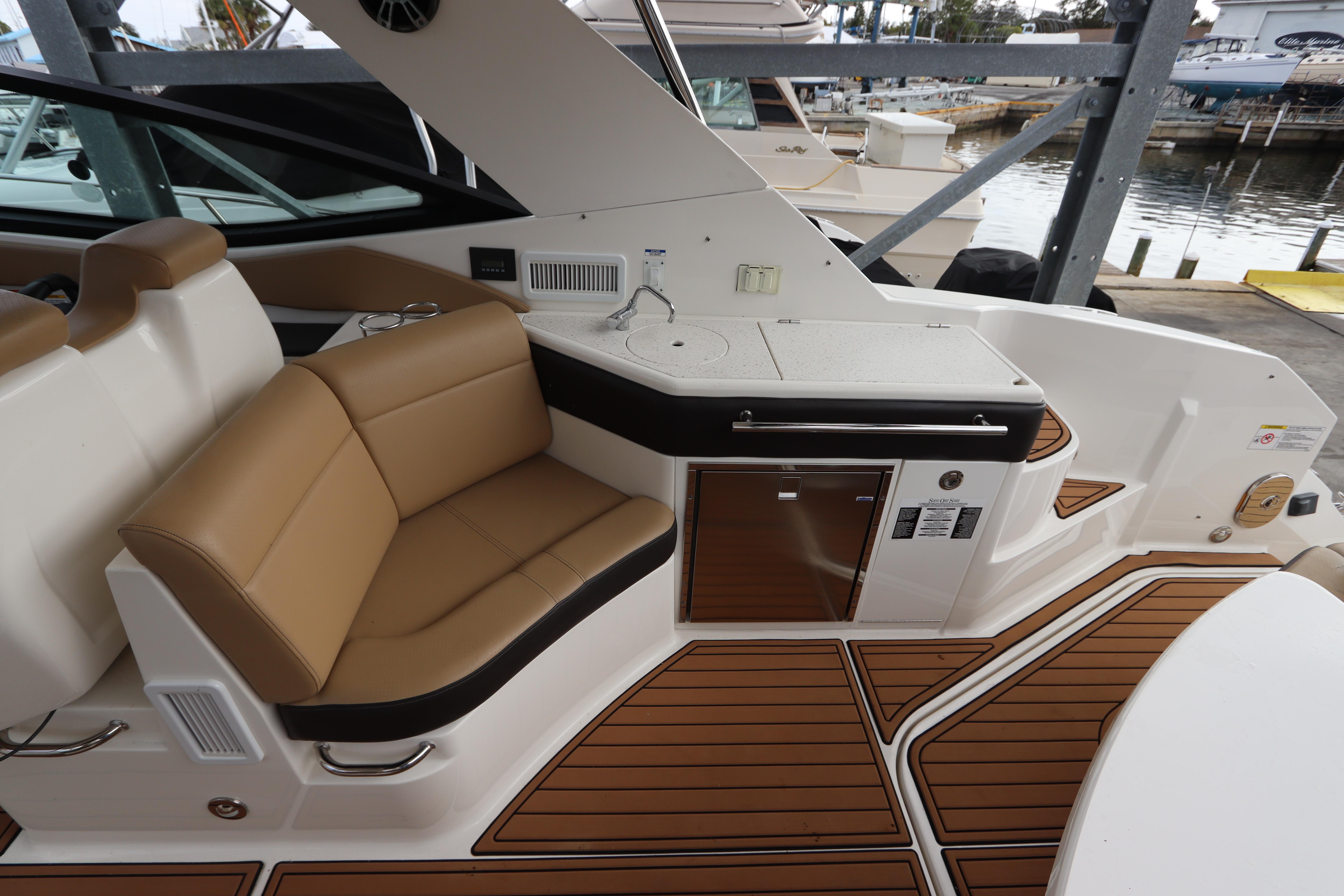 2019 Sea Ray Sundancer 320 yacht interior with tan seating and wood accents.