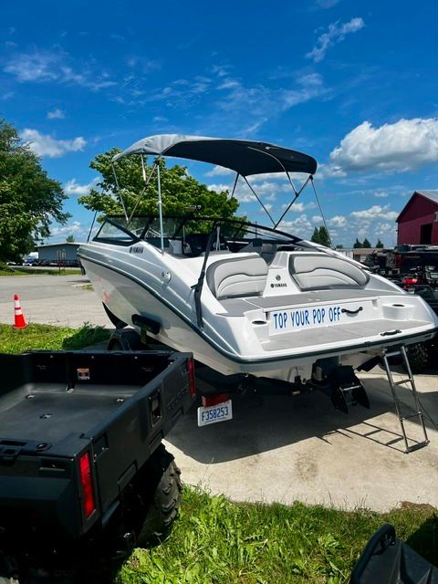 A 2023 Yamaha SX190 boat is on a trailer outdoors.