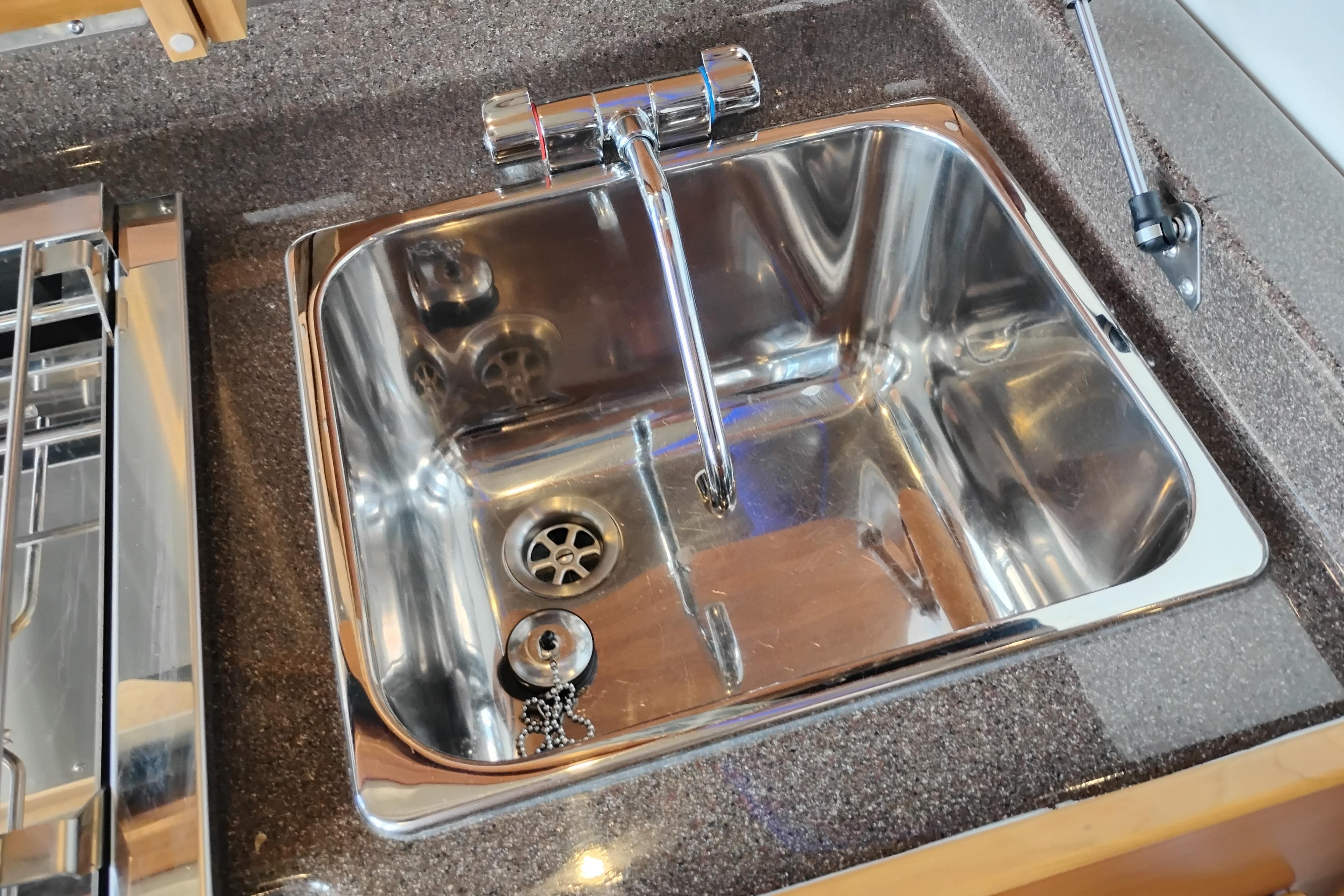 Stainless steel sink in 2022 Cutwater C-32 Coupe boat kitchen.