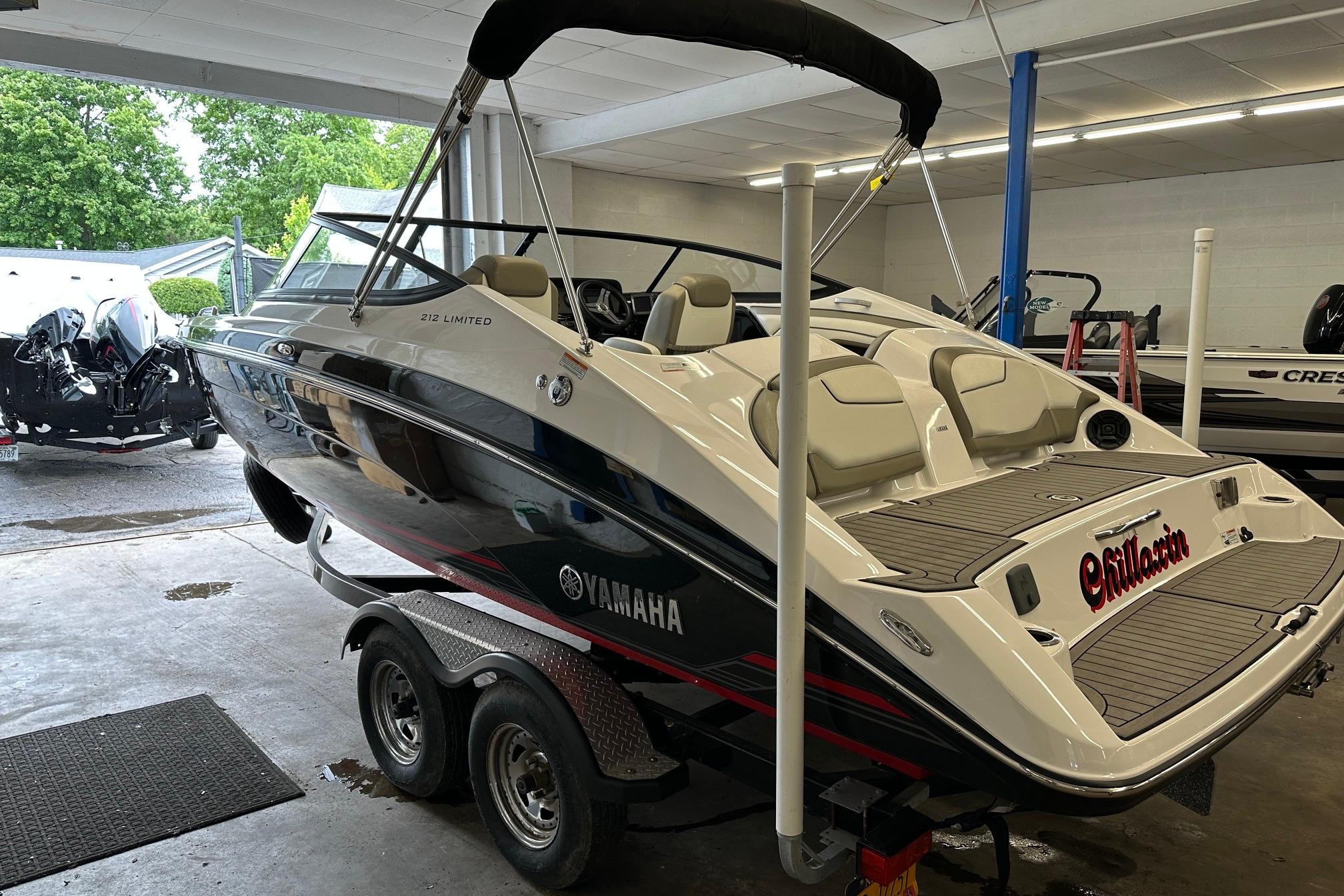 2018 Yamaha Boats 212 Limited in showroom, sleek design, dual engines, luxury seating.