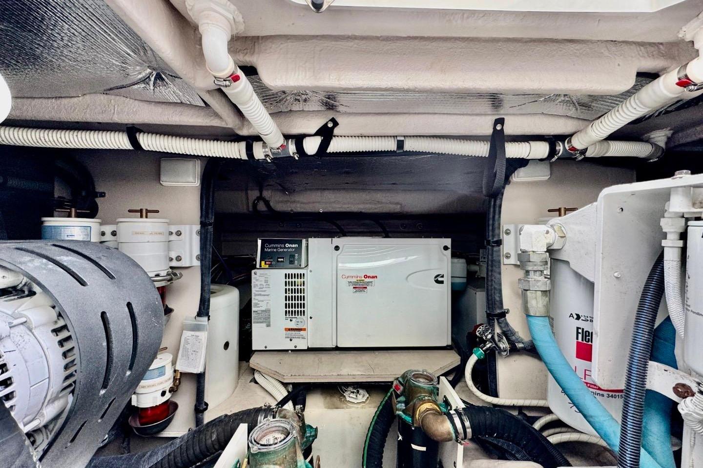 Engine room of 2008 Sea Ray 48 Sundancer with Cummins Onan generator and various mechanical components.