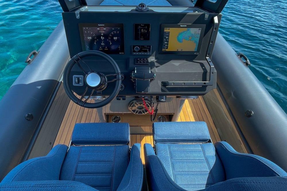 Cockpit of 2026 Rock Marine RM 36 boat with modern navigation system and blue seats.