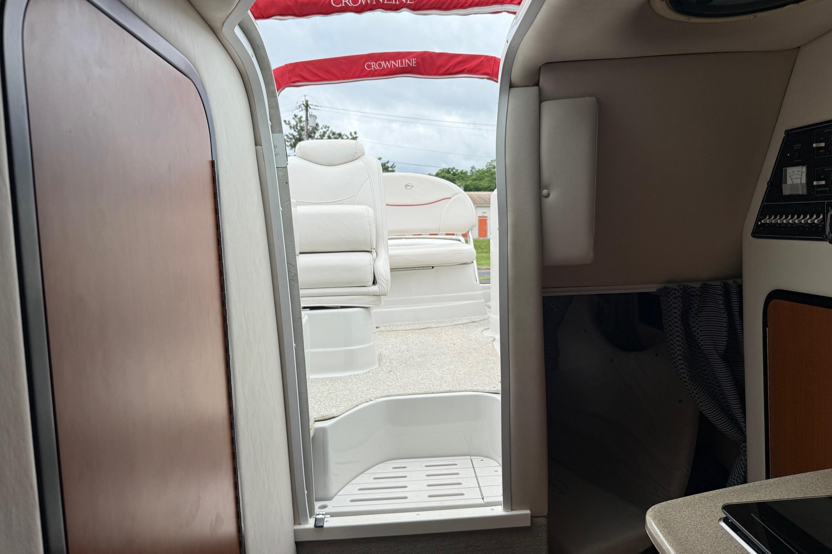 Interior view of a 2005 Crownline 250 CR boat, showing cabin entrance and seating.