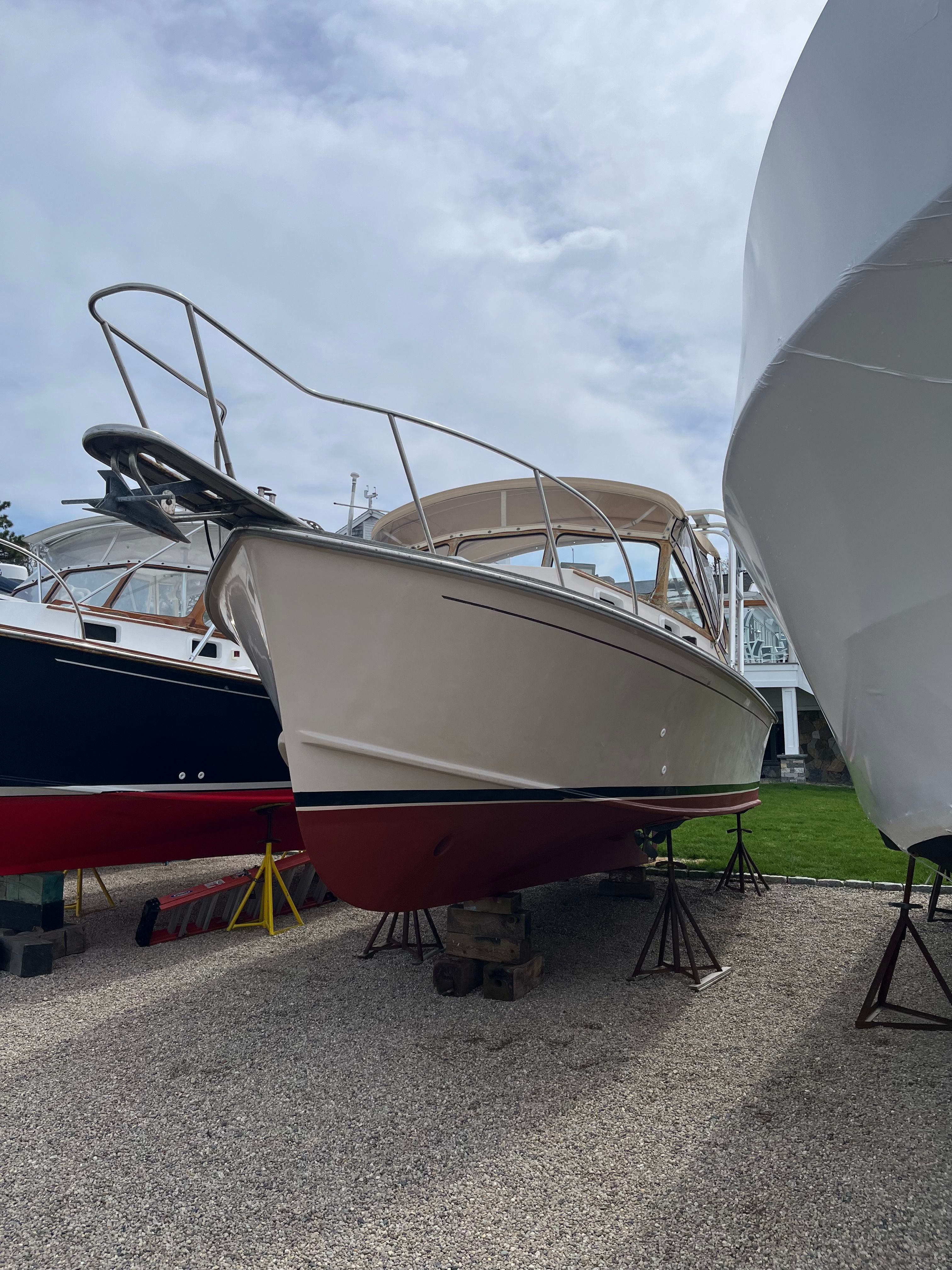 A 1989 Fortier 26 boat is on a dry dock.