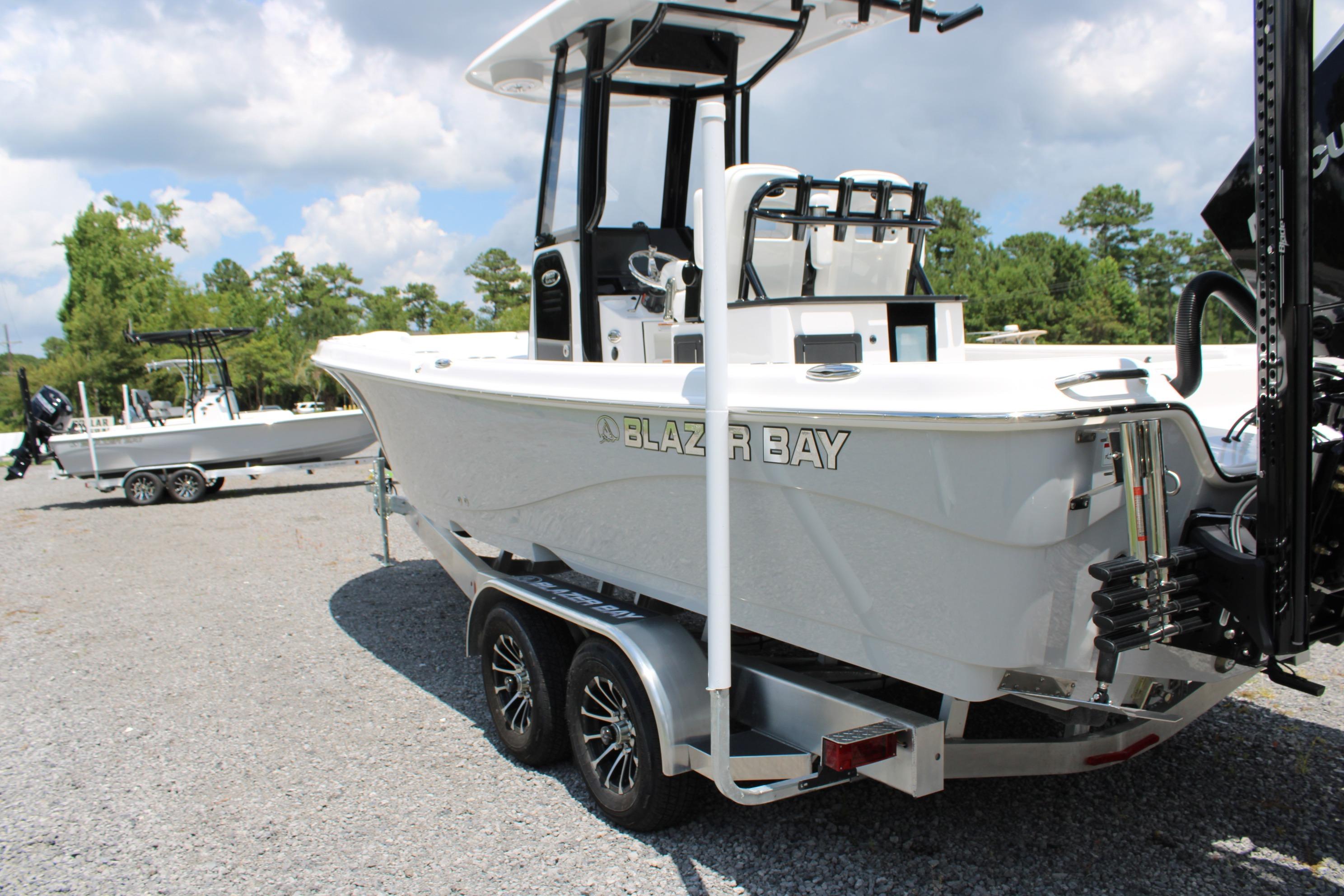 2027 Blazer Bay Makaira 2800 boat on trailer, parked outdoors under a cloudy sky.
