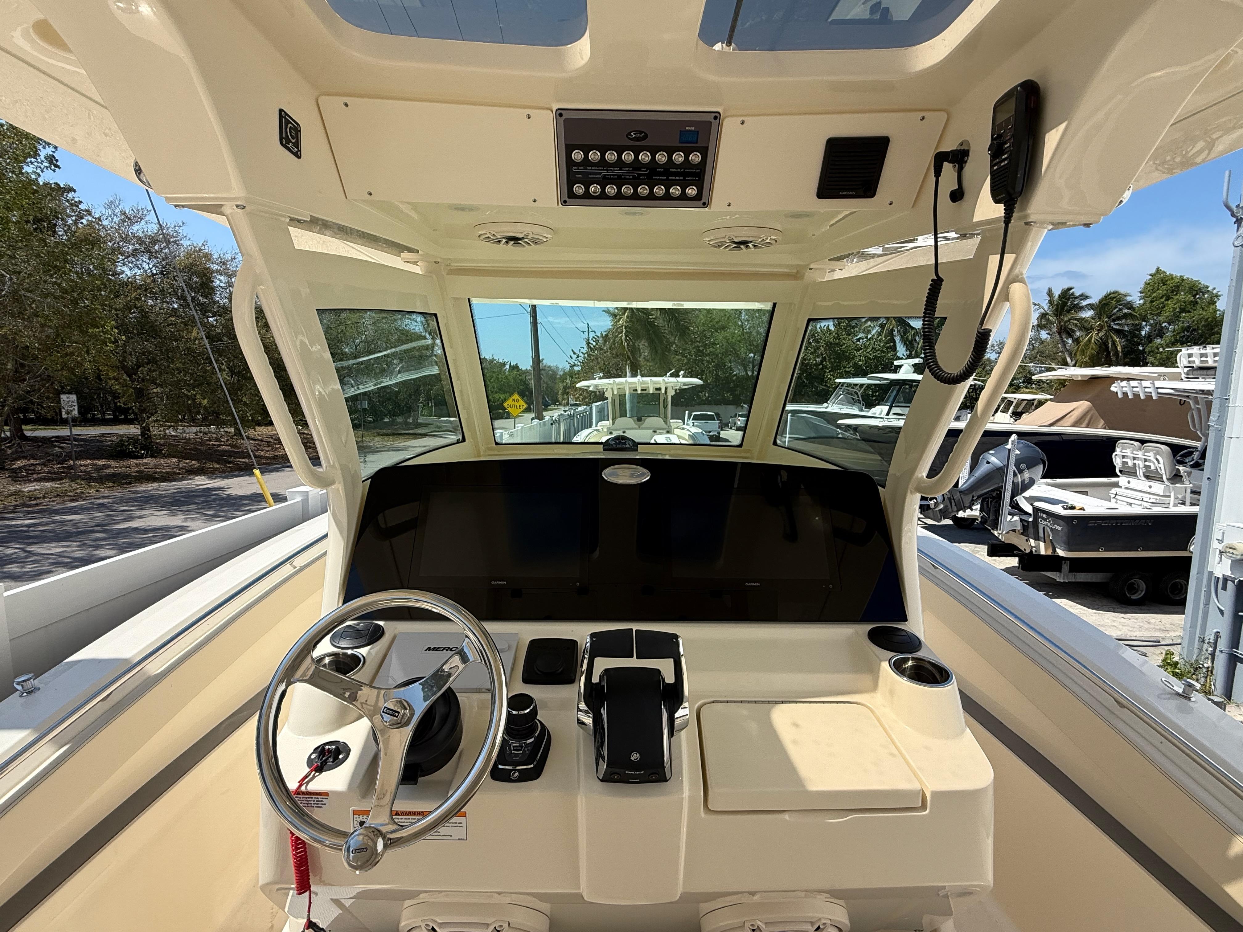 2025 Scout 330 LXF boat cockpit with steering wheel and control panel.