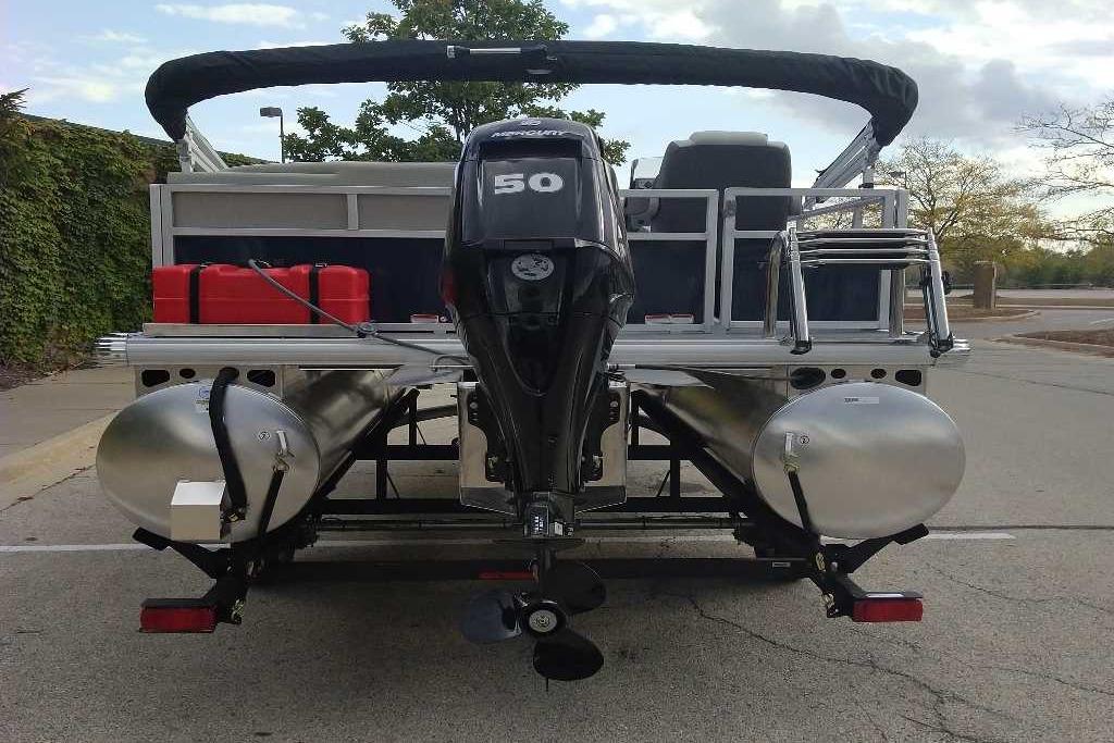 2026 Sun Tracker Bass Buggy 16 XL Select pontoon boat, rear view with motor and seating.