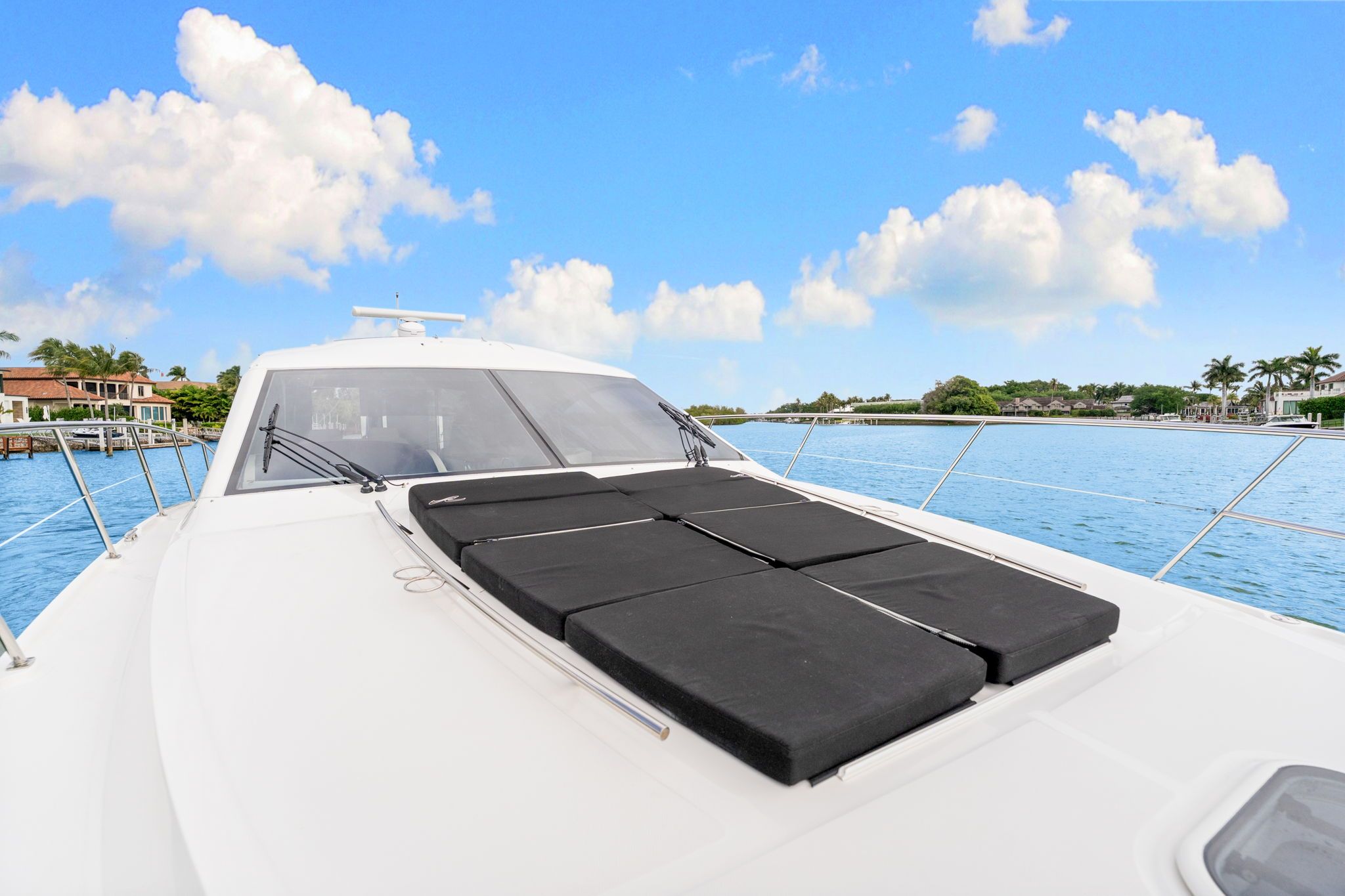 The 2017 Sea Ray Sundancer 510 is on calm water with a sunny sky in the background.
